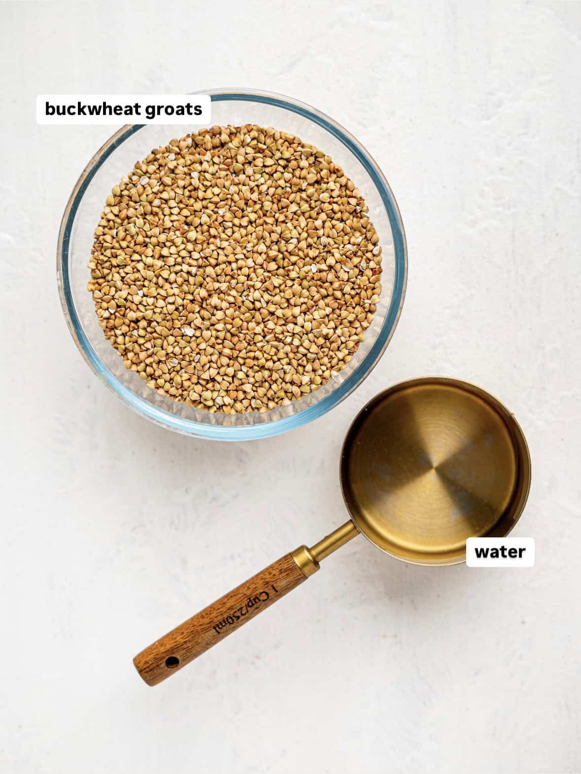 Ingredients for buckwheat bread on a counter: buckwheat groats and water