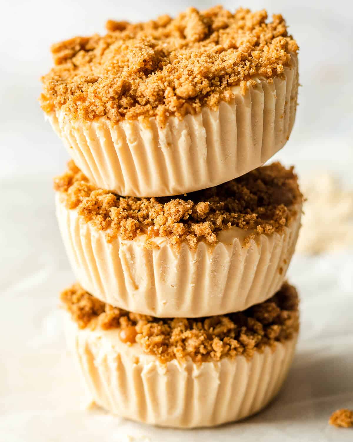 Three mini biscoff cheesecakes stacked on top of each other.