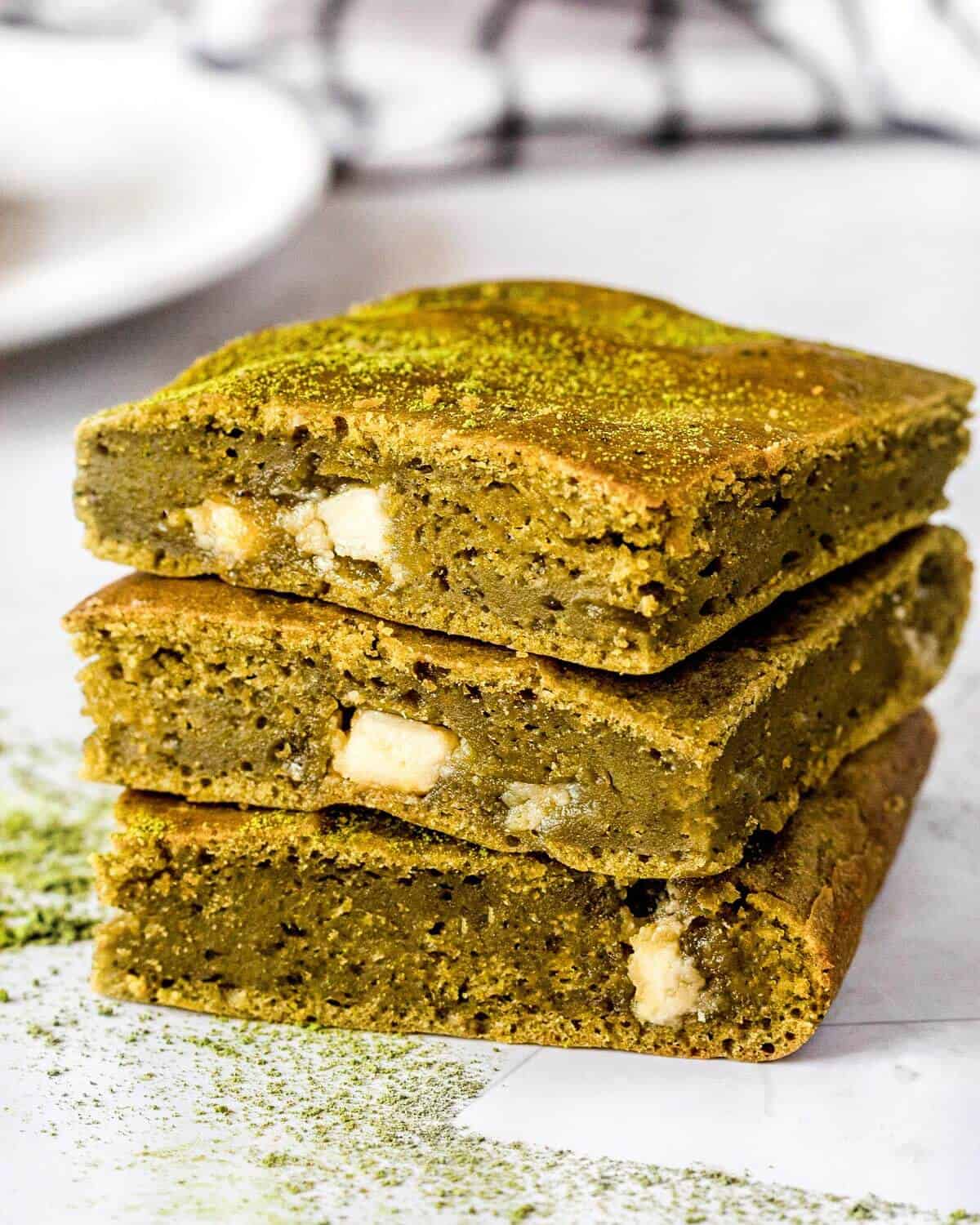 Three green tea brownies stacked on top of each other.