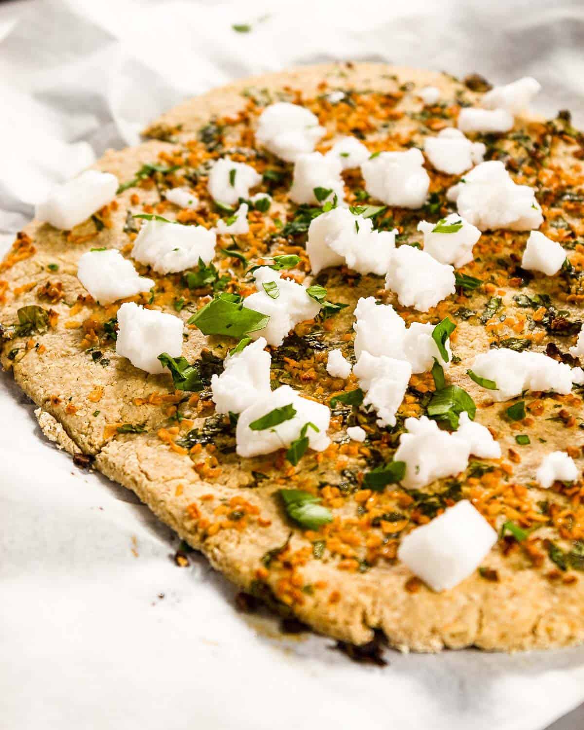 Thin crust pizza with garlic, parsley and feta.