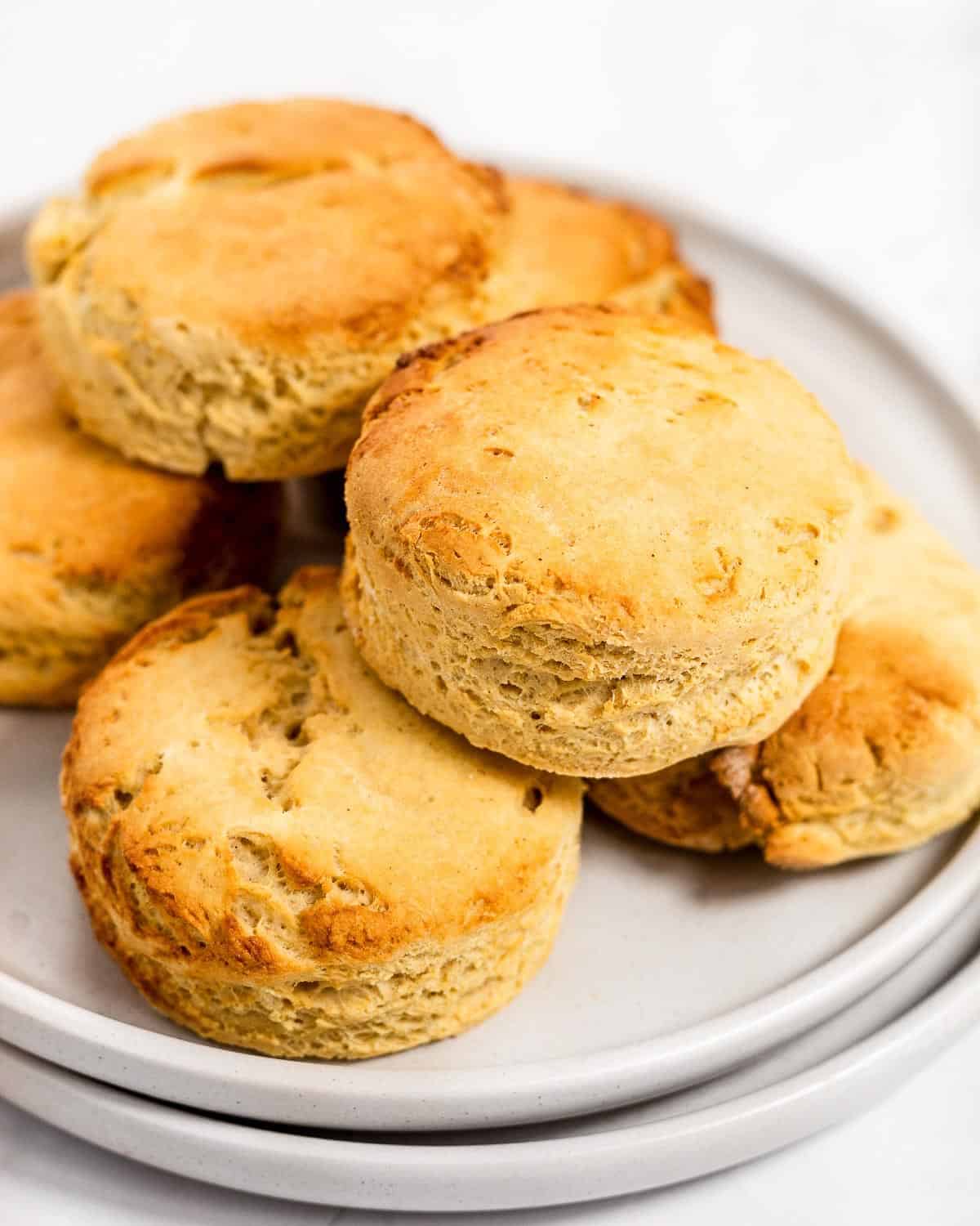 A stack of freshly baked scones on a grey plate.