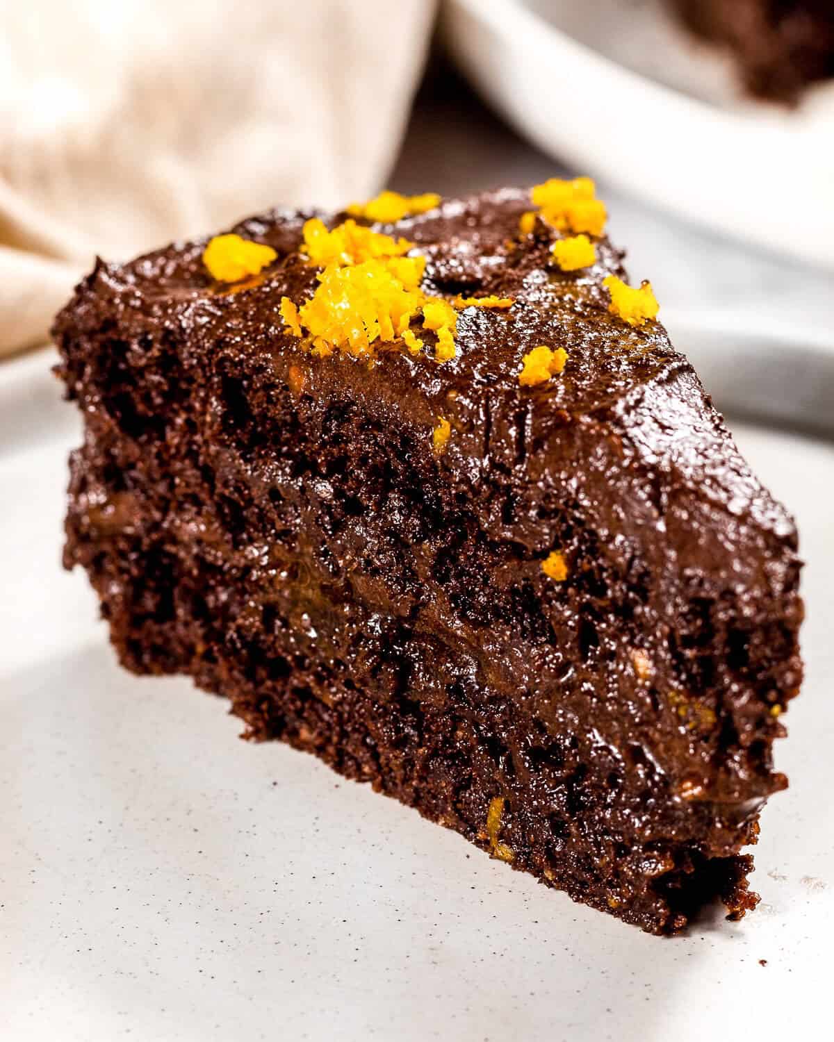 A close up image of chocolate orange cake with healthy chocolate frosting.