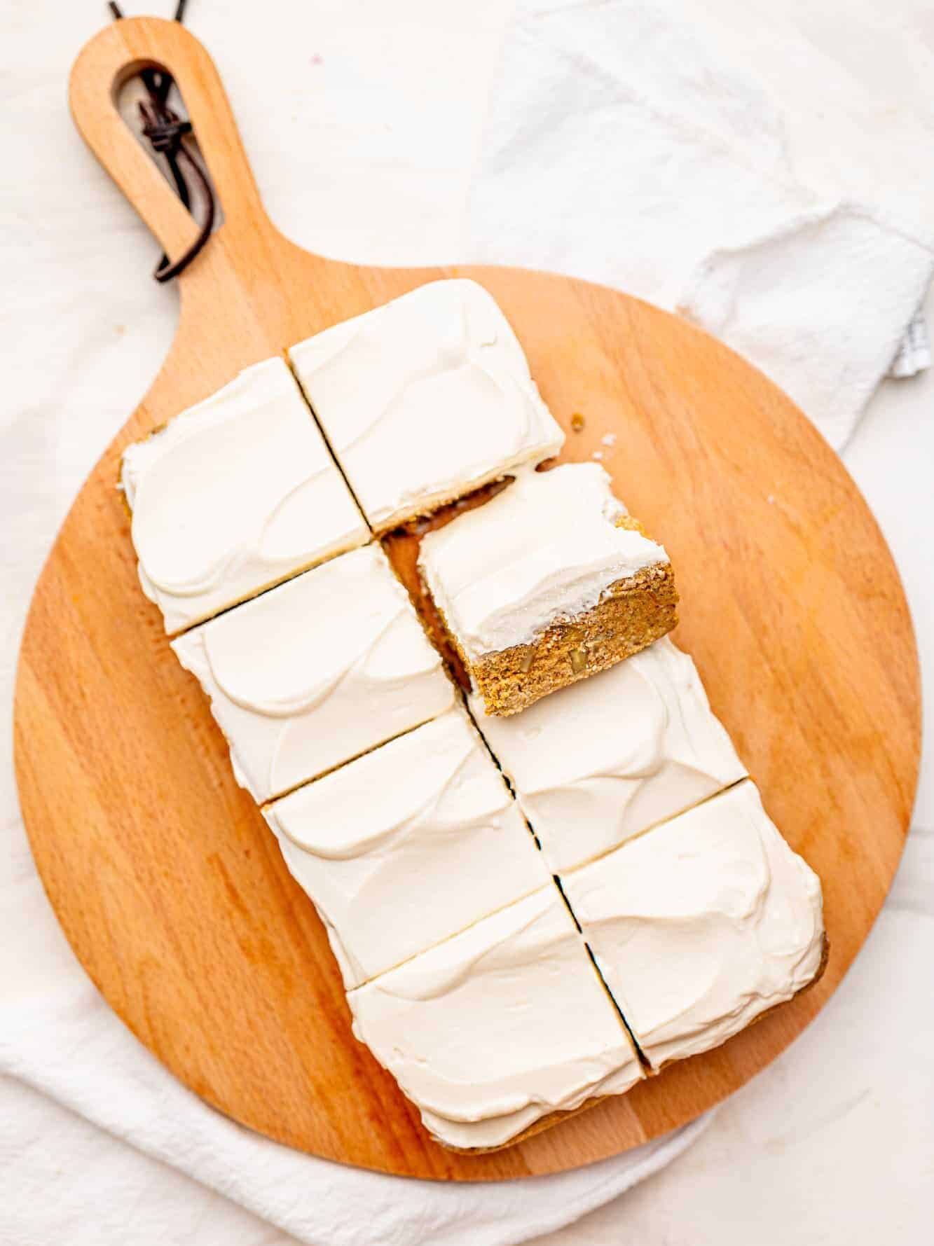 No-bake Carrot Cake Bars on a wooden board.