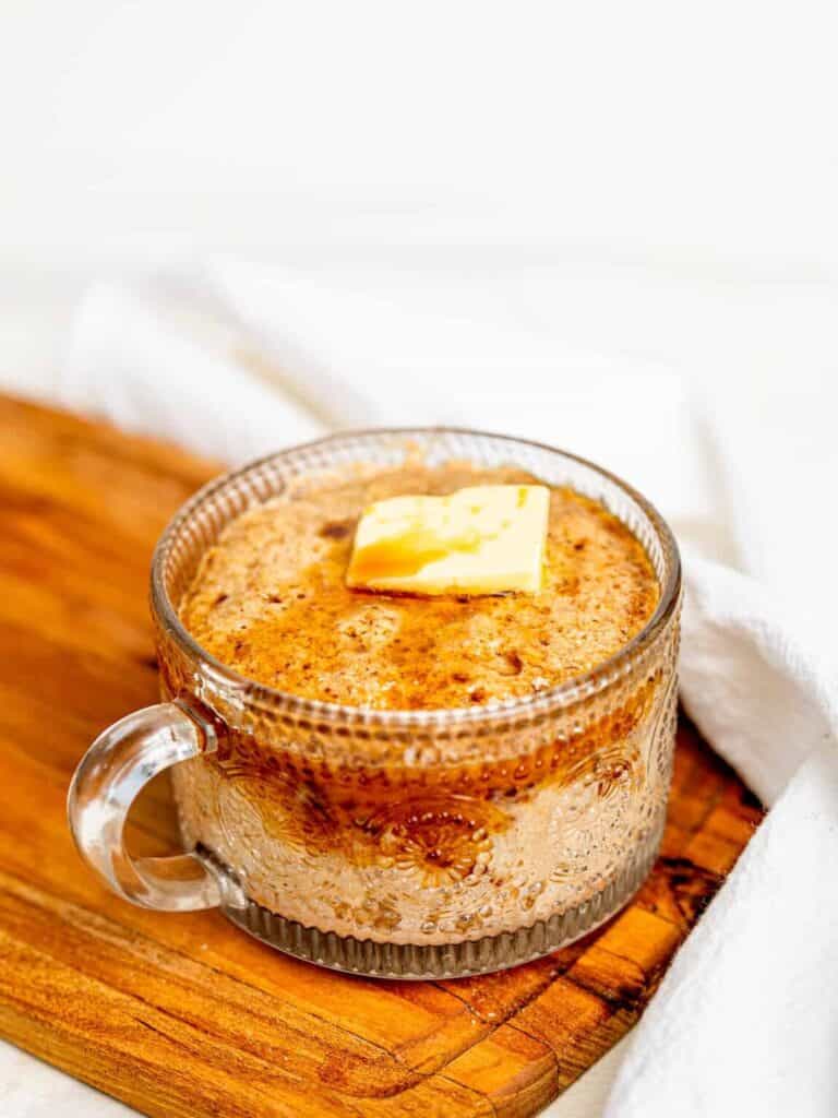 Microwave pancake in a mug with butter and maple syrup.