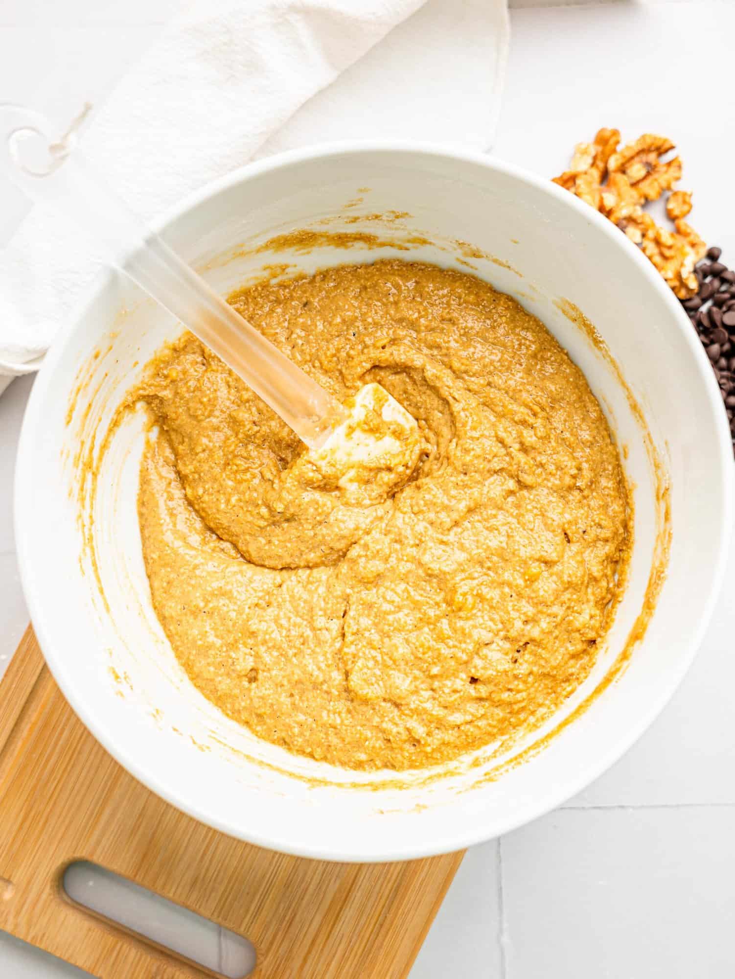 healthy oat flour banana bread ingredients combined in a bowl.