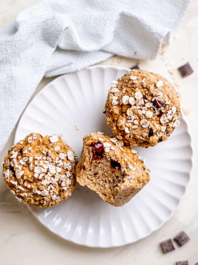 Healthy banana oatmeal muffins served on a white plate from above.