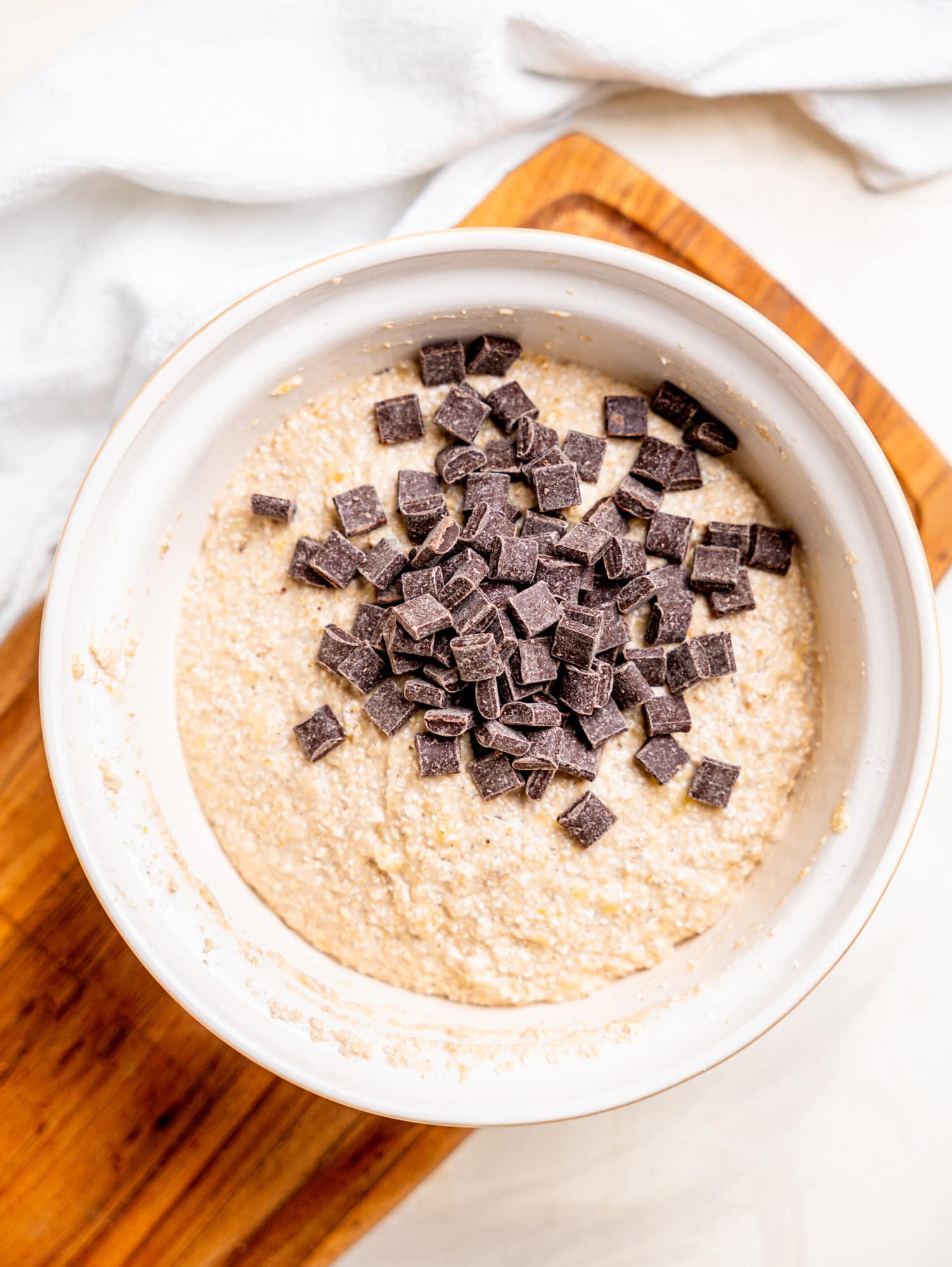 Banana and oatmeal muffin batter with dark chocolate chips.