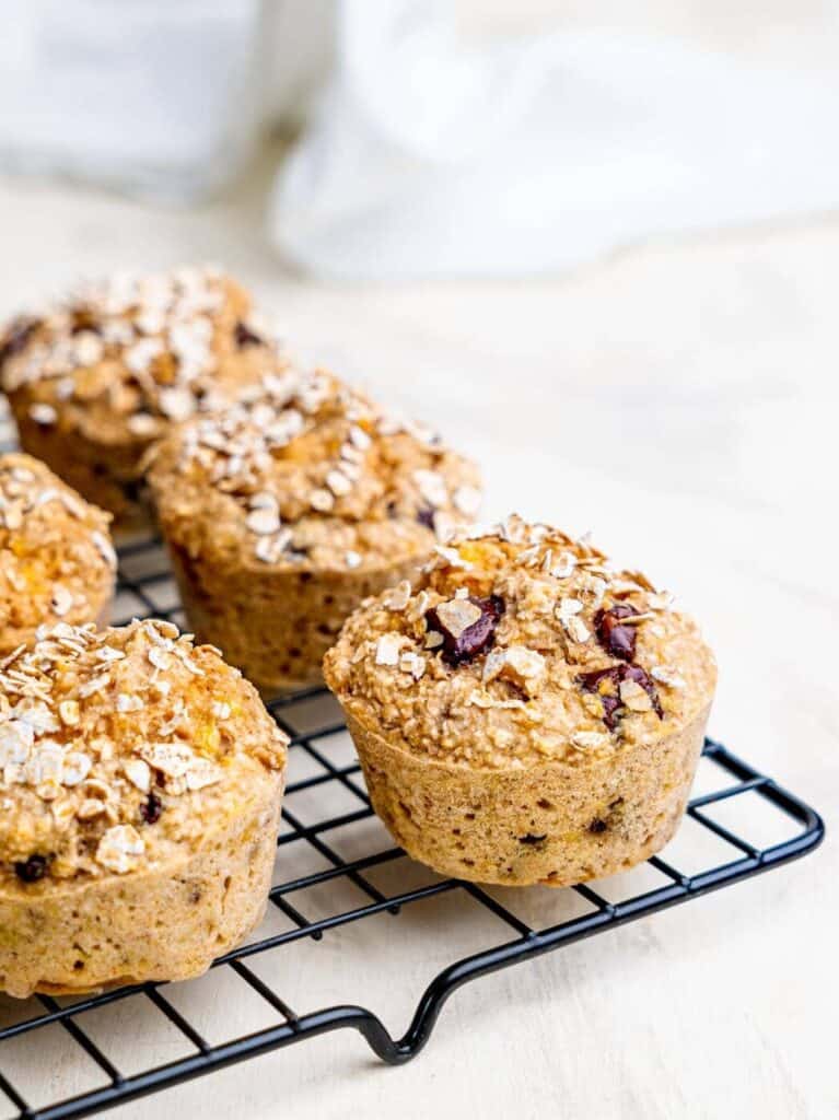Freshly baked healthy banana oatmeal muffins cooling on a wire rack.