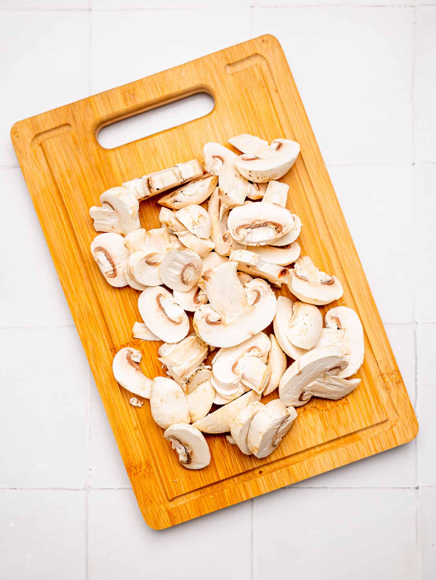 Sliced mushrooms for the feta chicken bake.