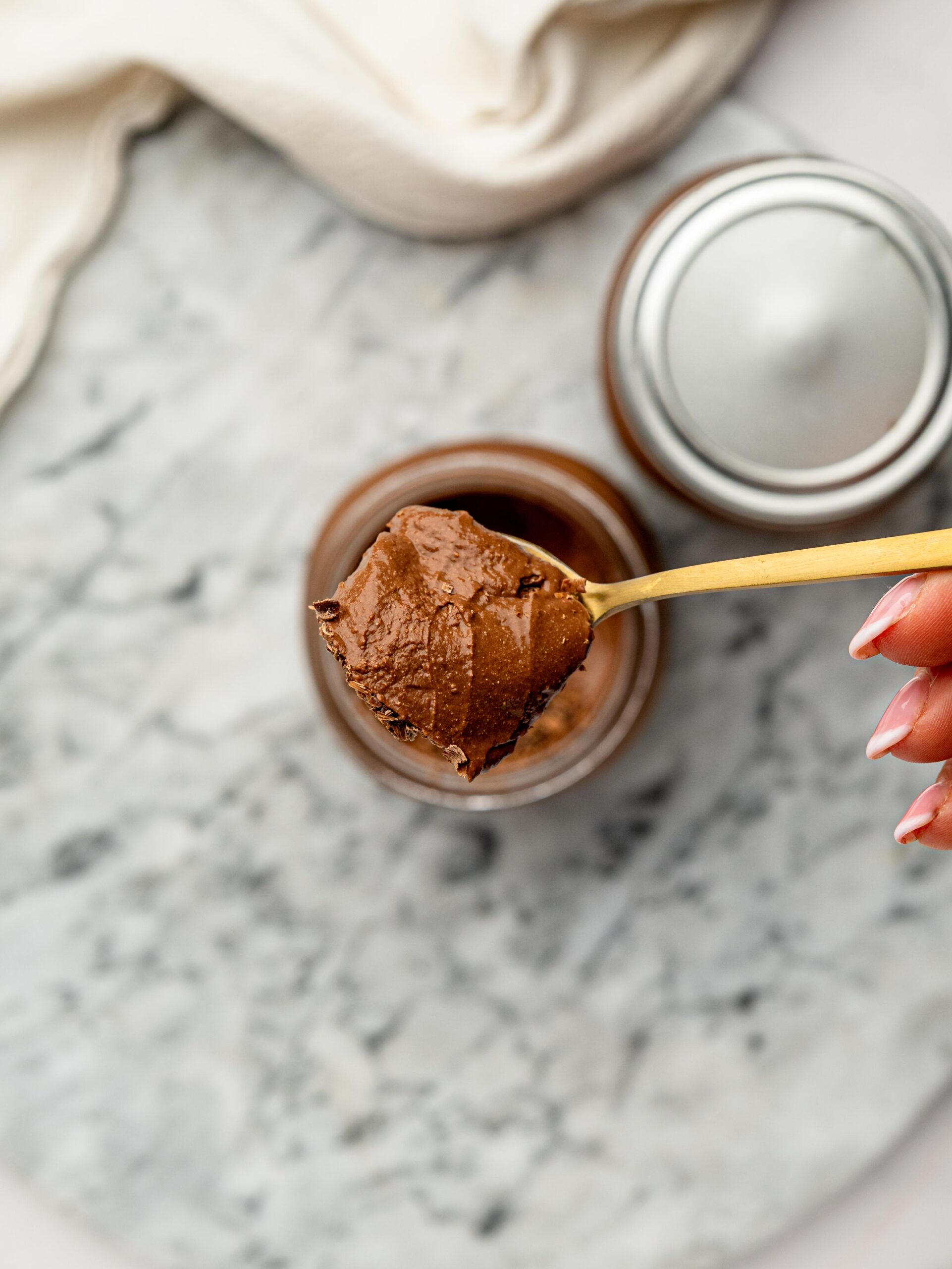 Overhead view of Healthy Cottage Cheese Chocolate Mousse in a glass jar.