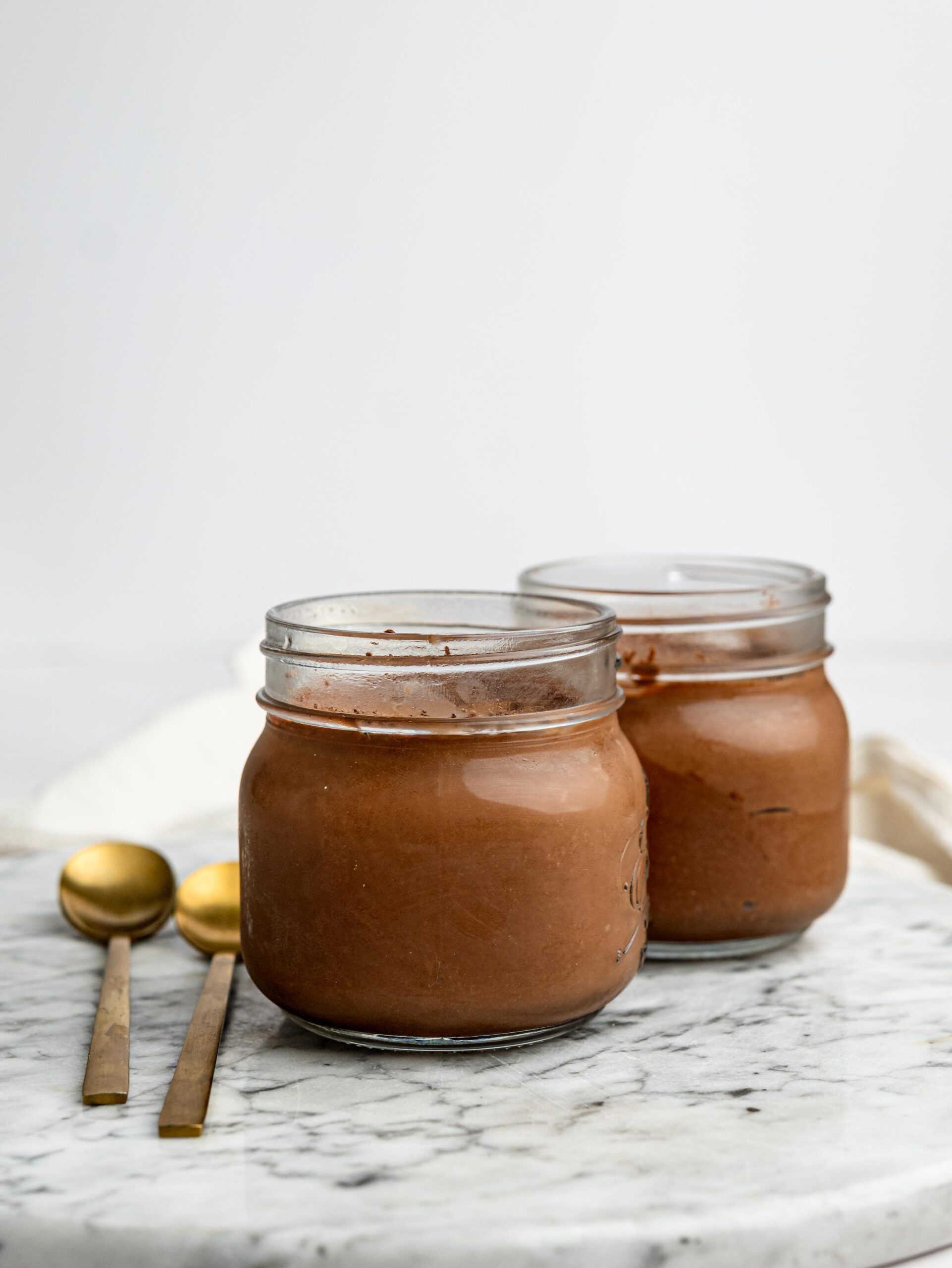 Healthy Cottage Cheese Chocolate Mousse served in two glass jars.