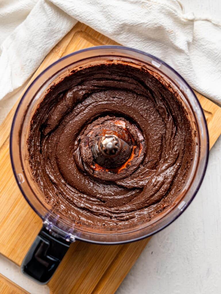 Blended cottage cheese fudge ingredients in a food processor.