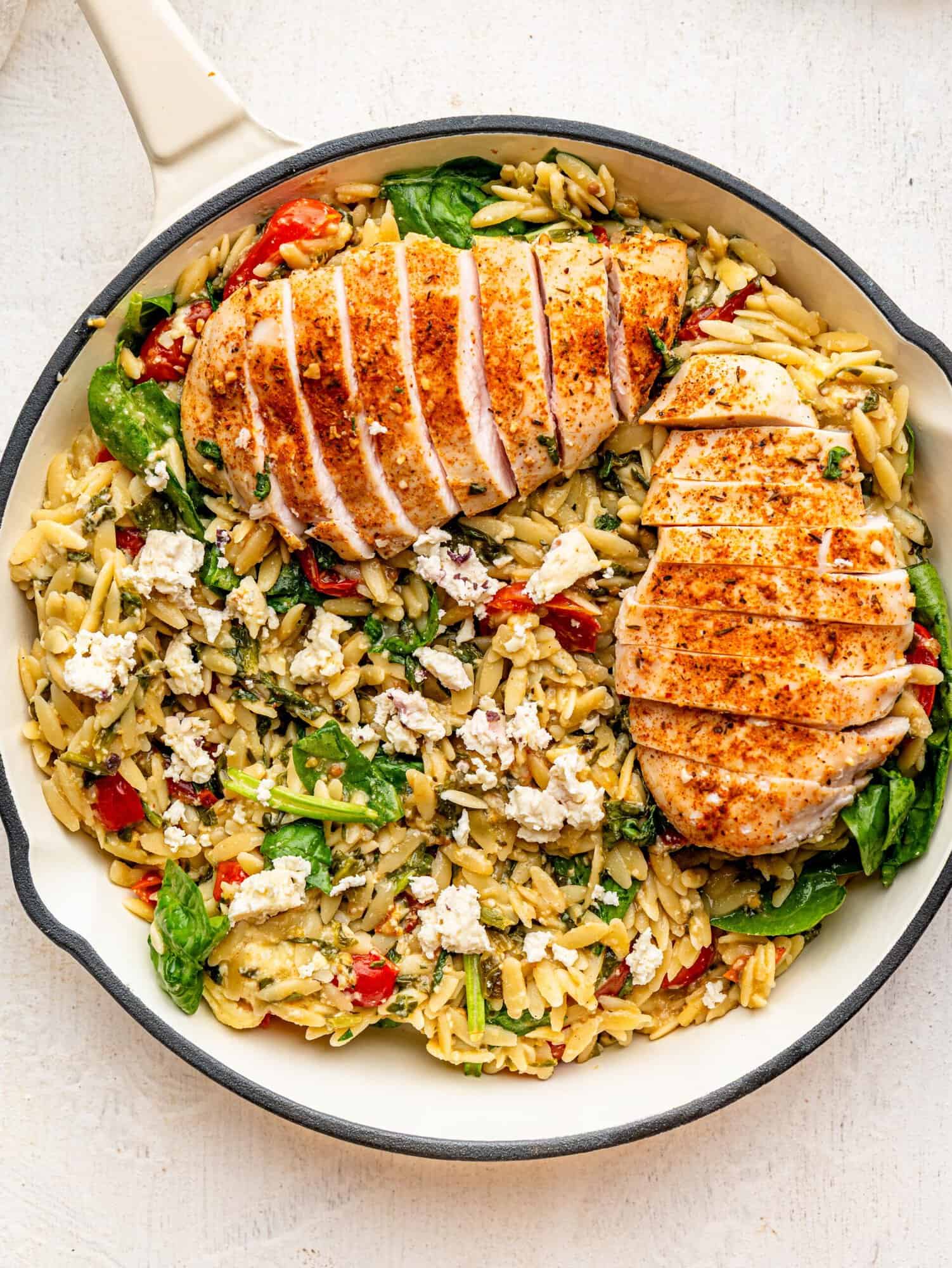 Chicken and Orzo Bake in a white skillet.
