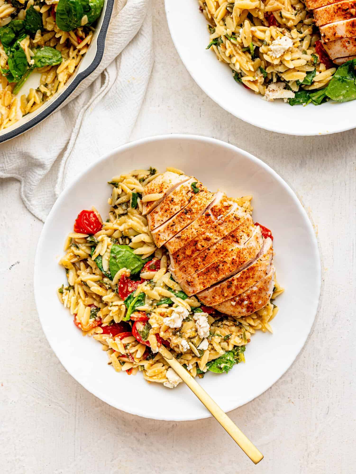 Chicken and Orzo bake in a white bowl.