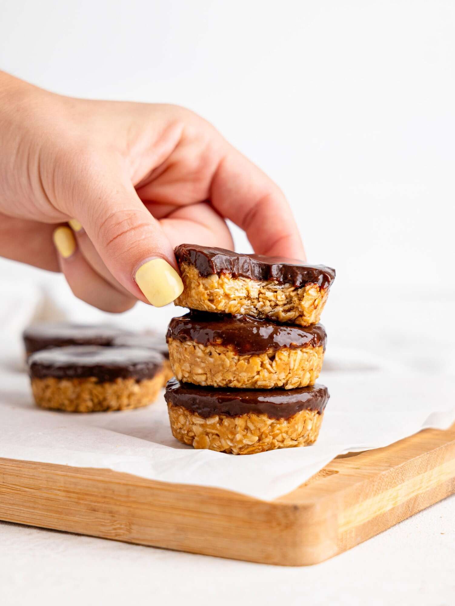 Three chocolate peanut butter oatmeal cups stacked on top of each other.