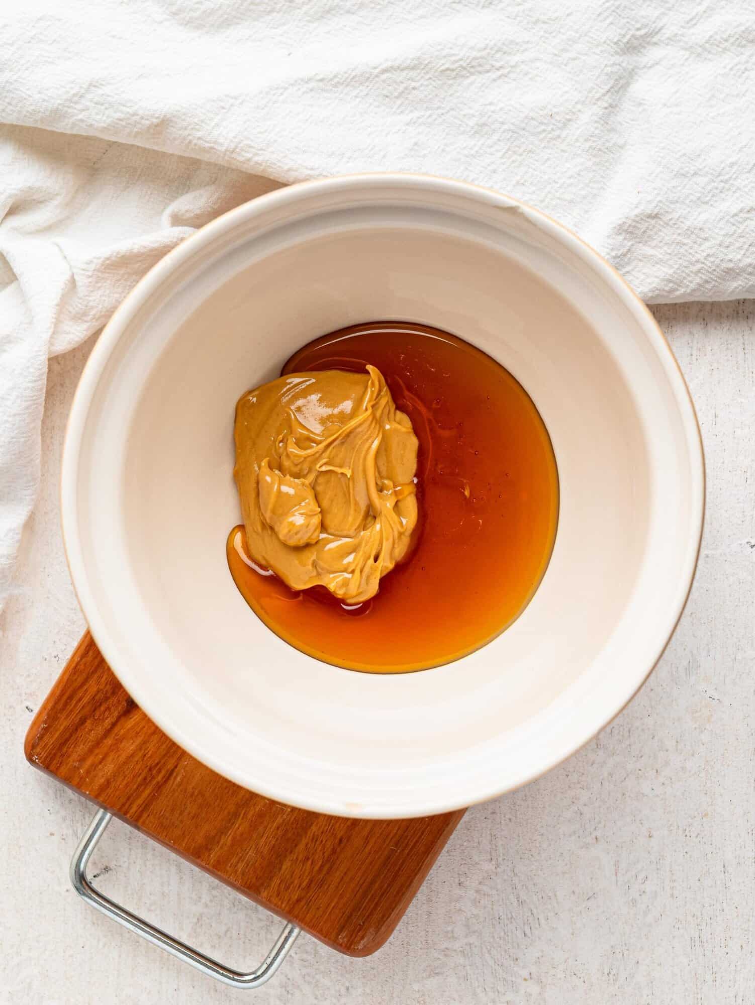Peanut butter and honey in a mixing bowl.