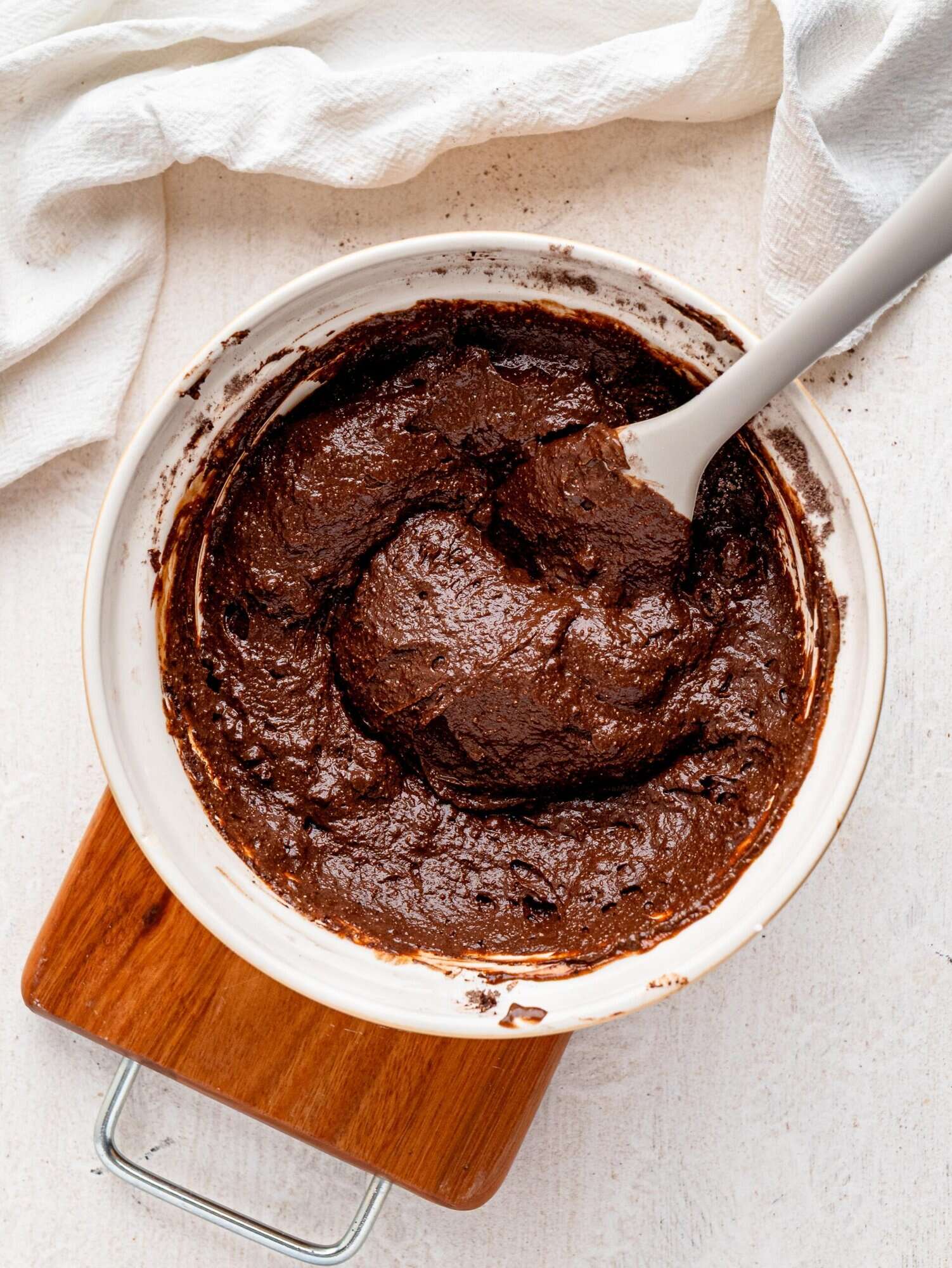 Espresso brownie batter in a white bowl.