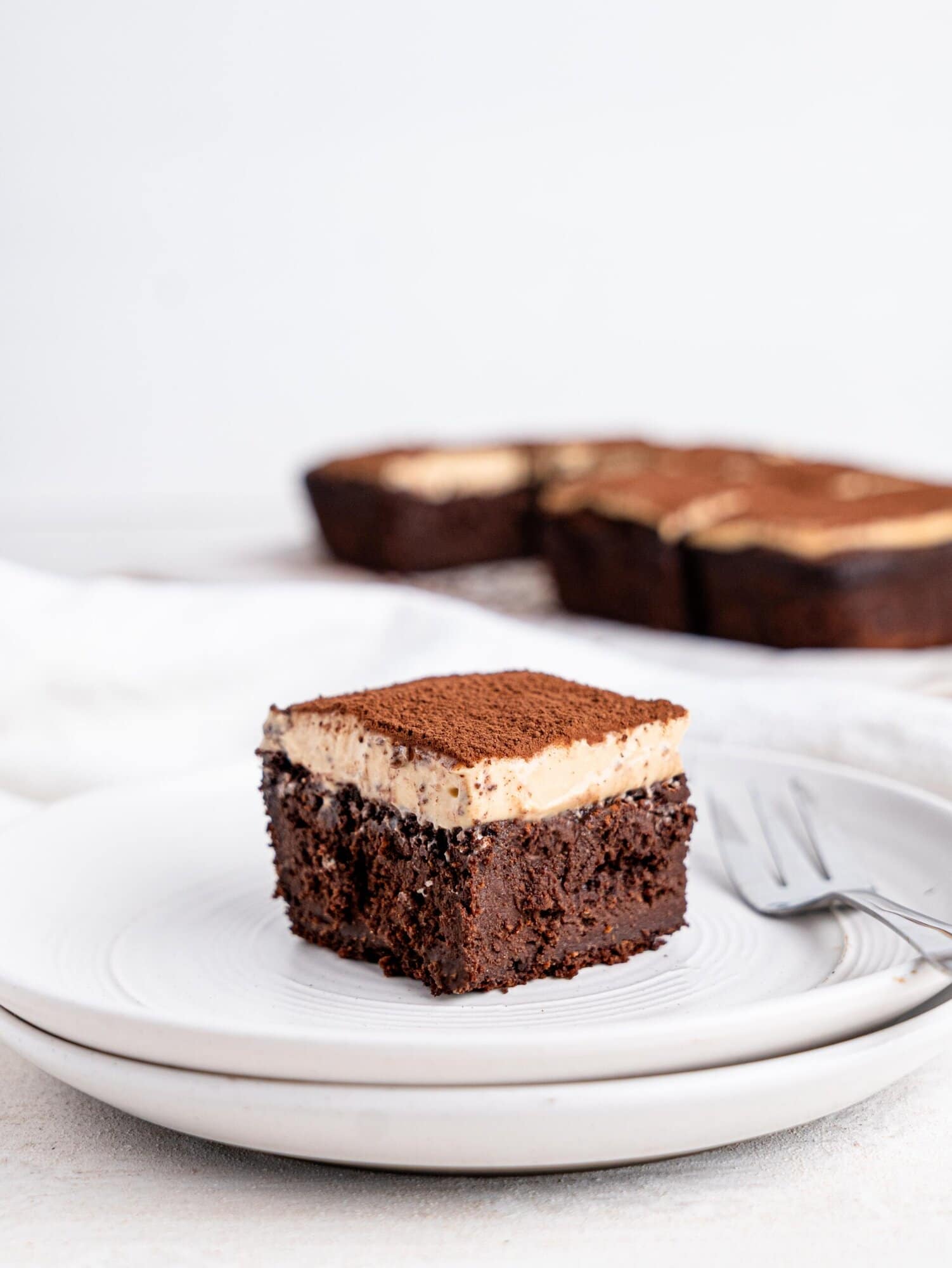 A tiramisu brownie on a white plate.