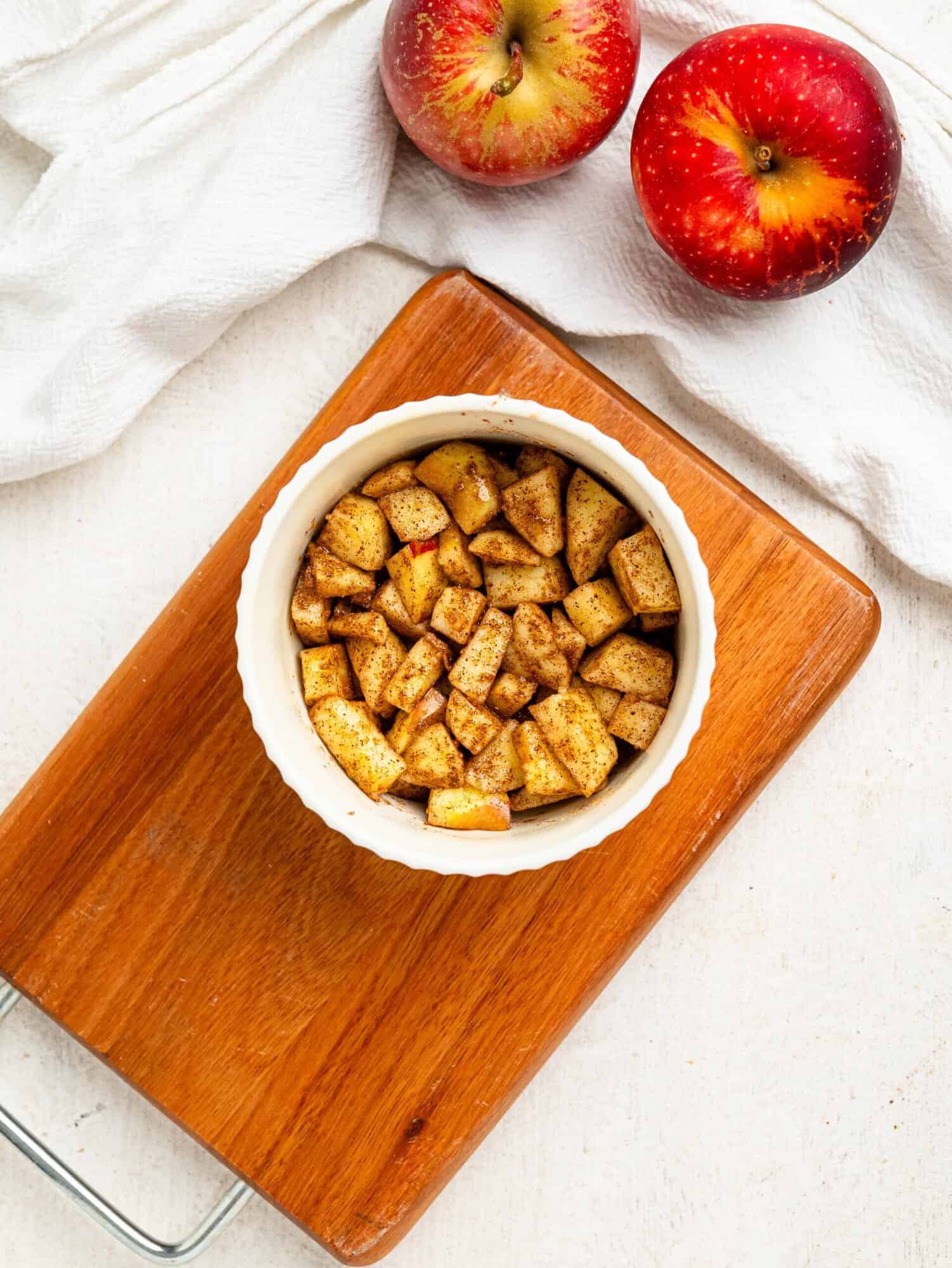 Chopped apple, coconut sugar and cinnamon in a small ramekin.