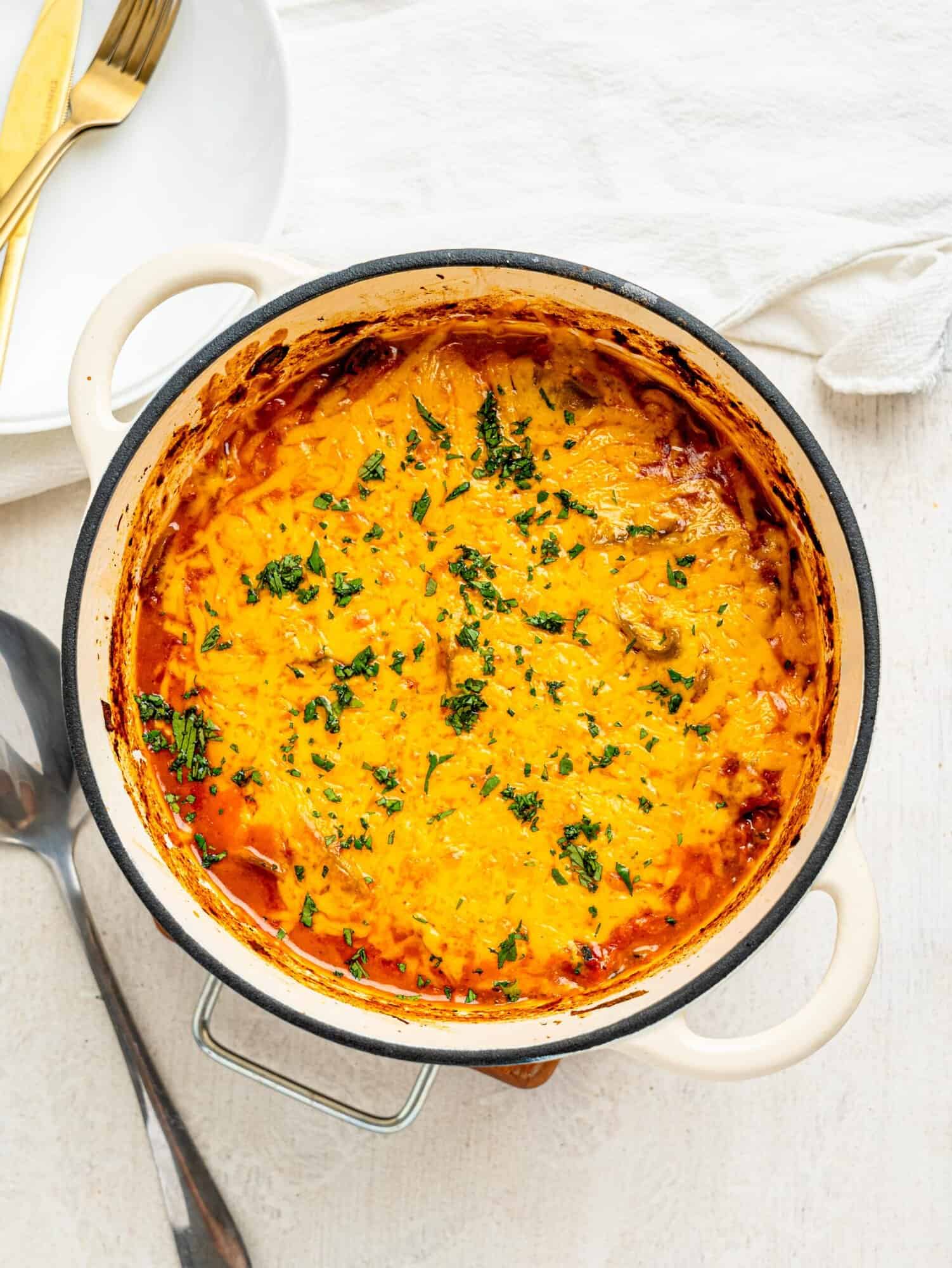 Deconstructed lasagna in a white pot.