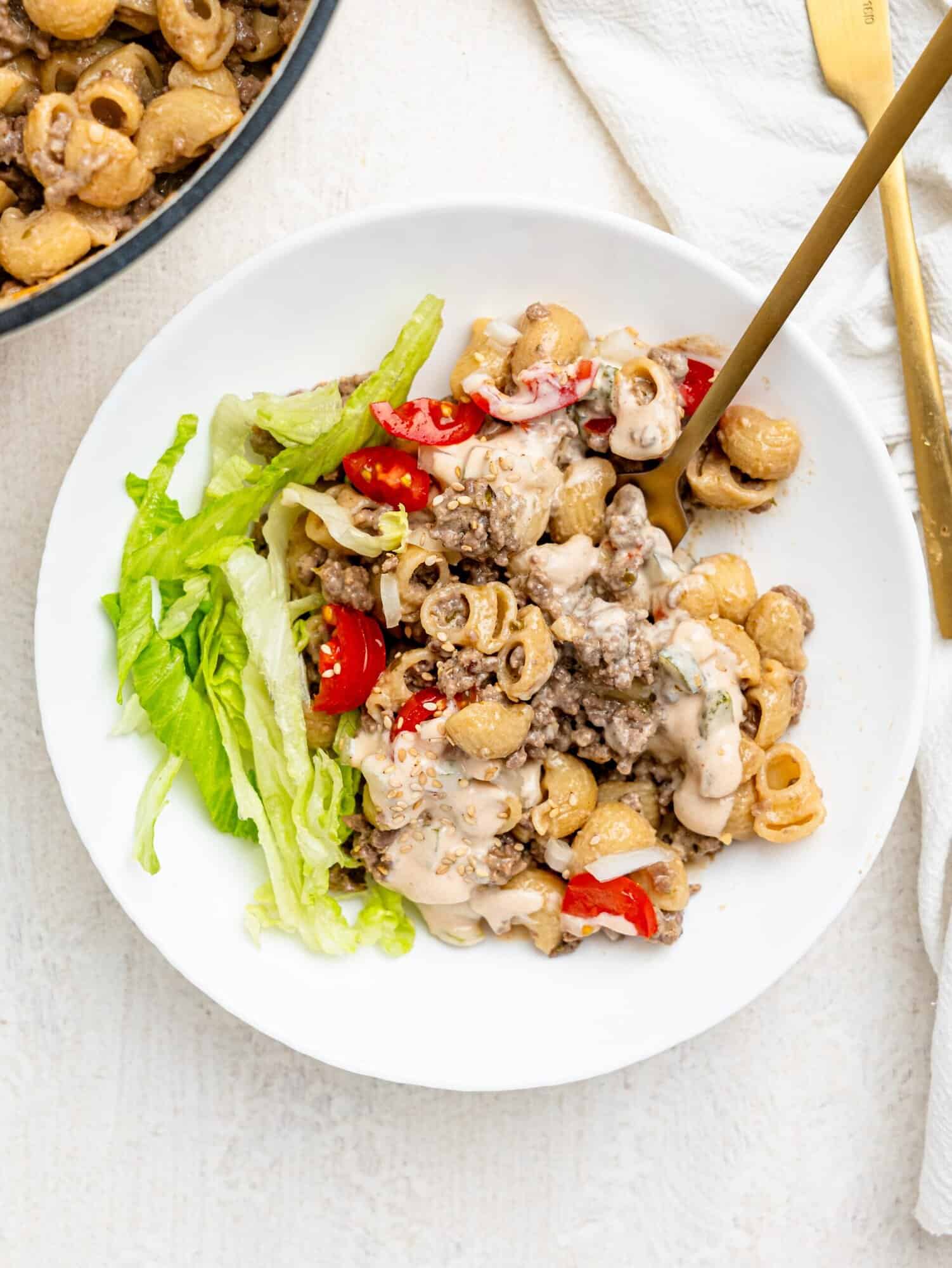 Cheeseburger pasta in a white bowl.