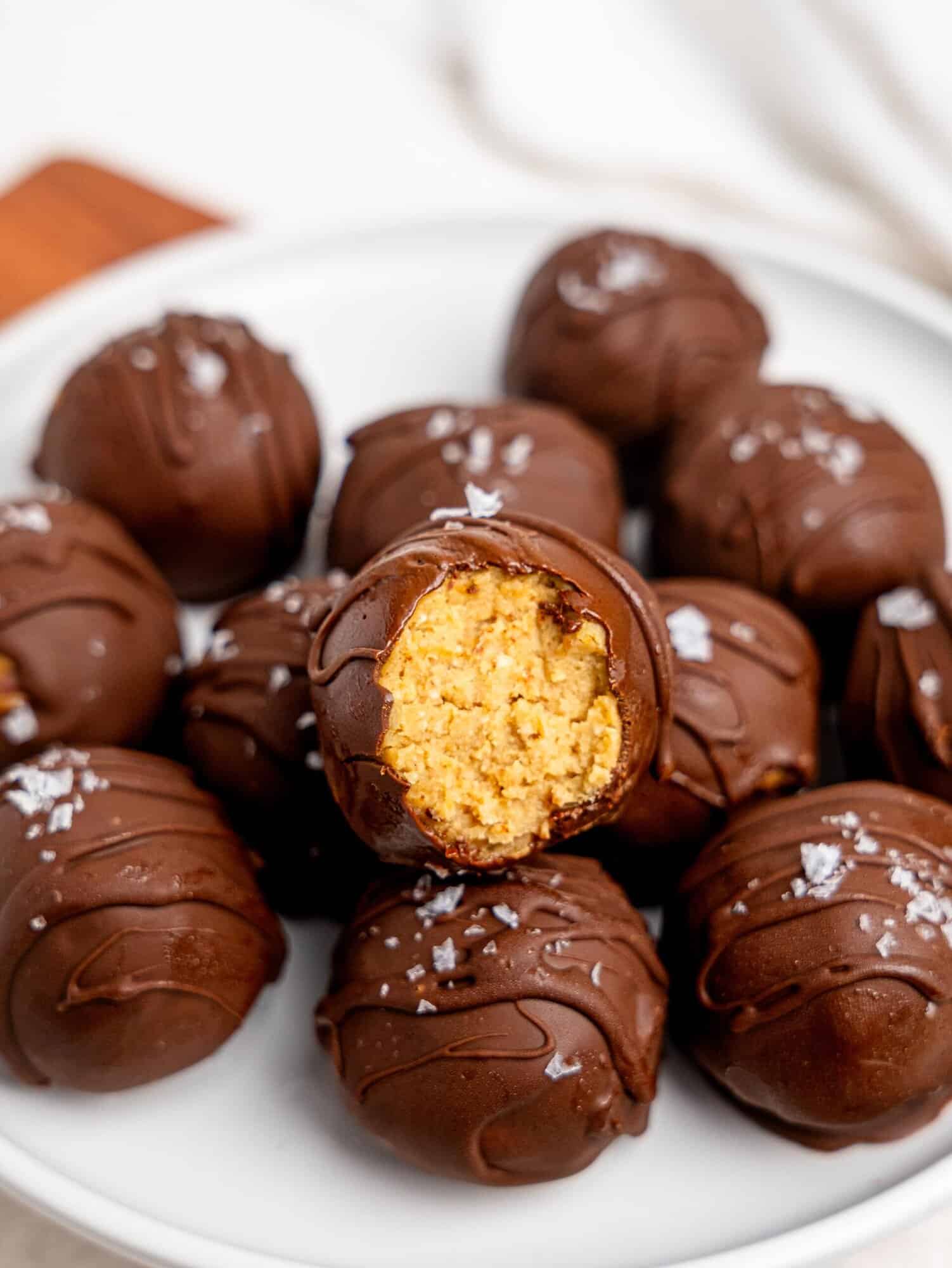 Chickpea cookie dough truffles on a white plate.