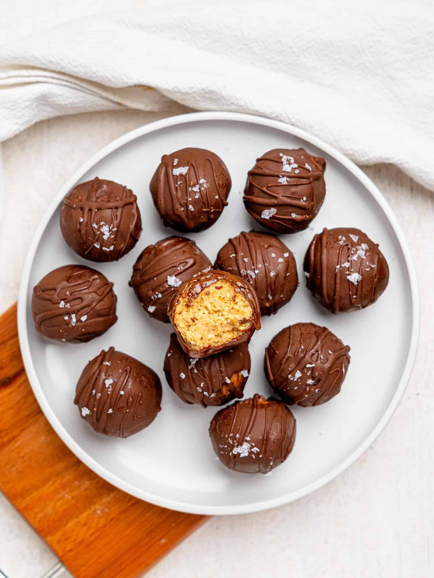 Chickpea cookie dough balls on a white plate.