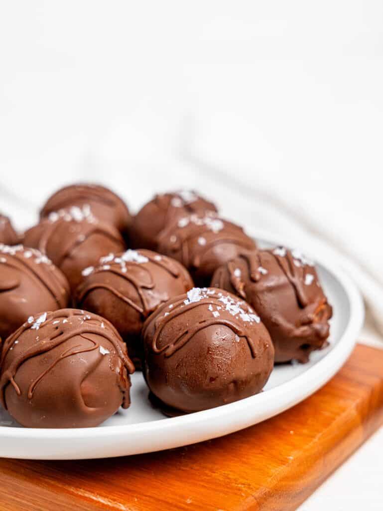 Chickpea cookie dough balls on a white plate.