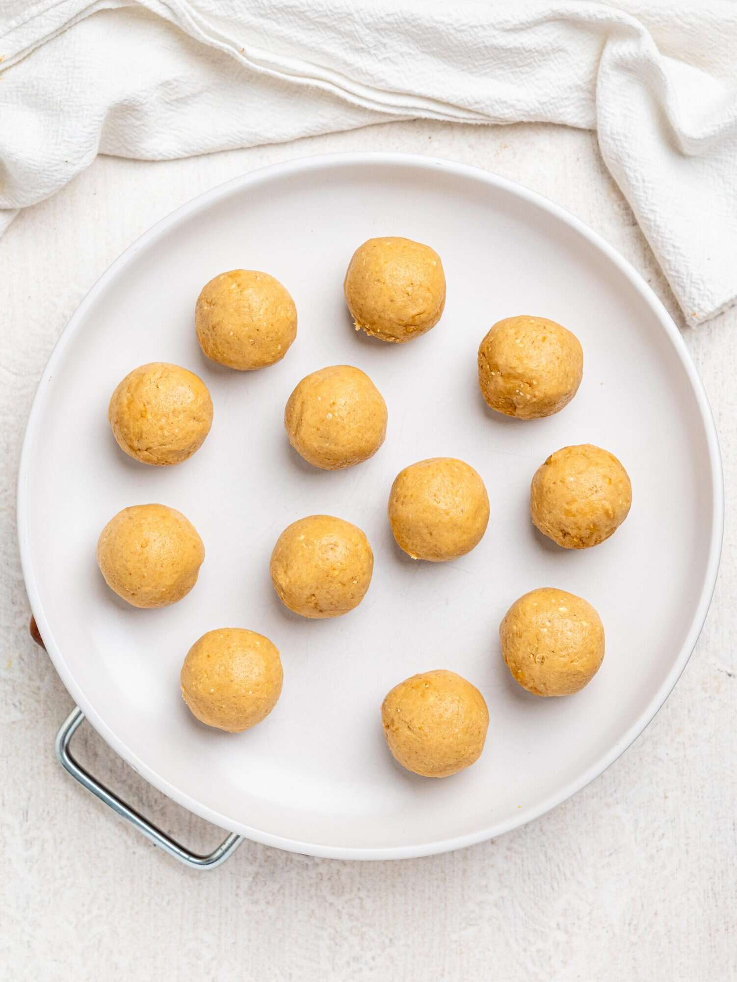 Healthy chickpea cookie dough balls on a white plate.