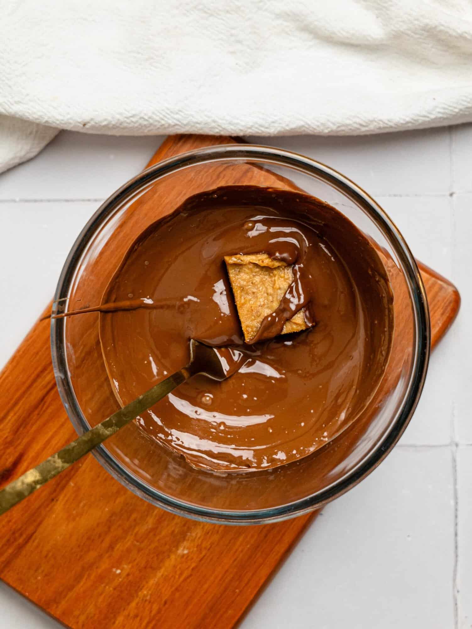 Dipping a date caramel in dark chocolate.