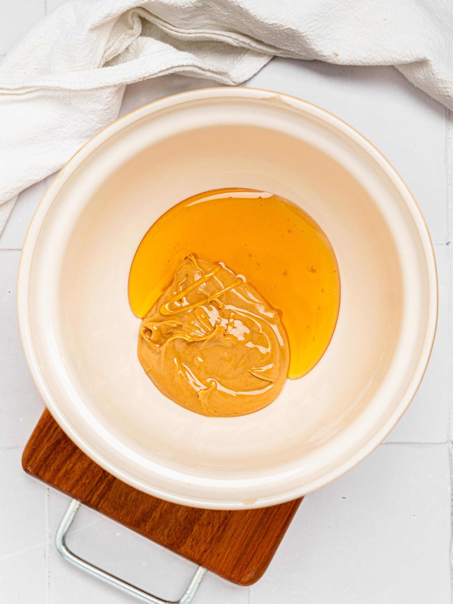 Peanut butter and honey in a mixing bowl.
