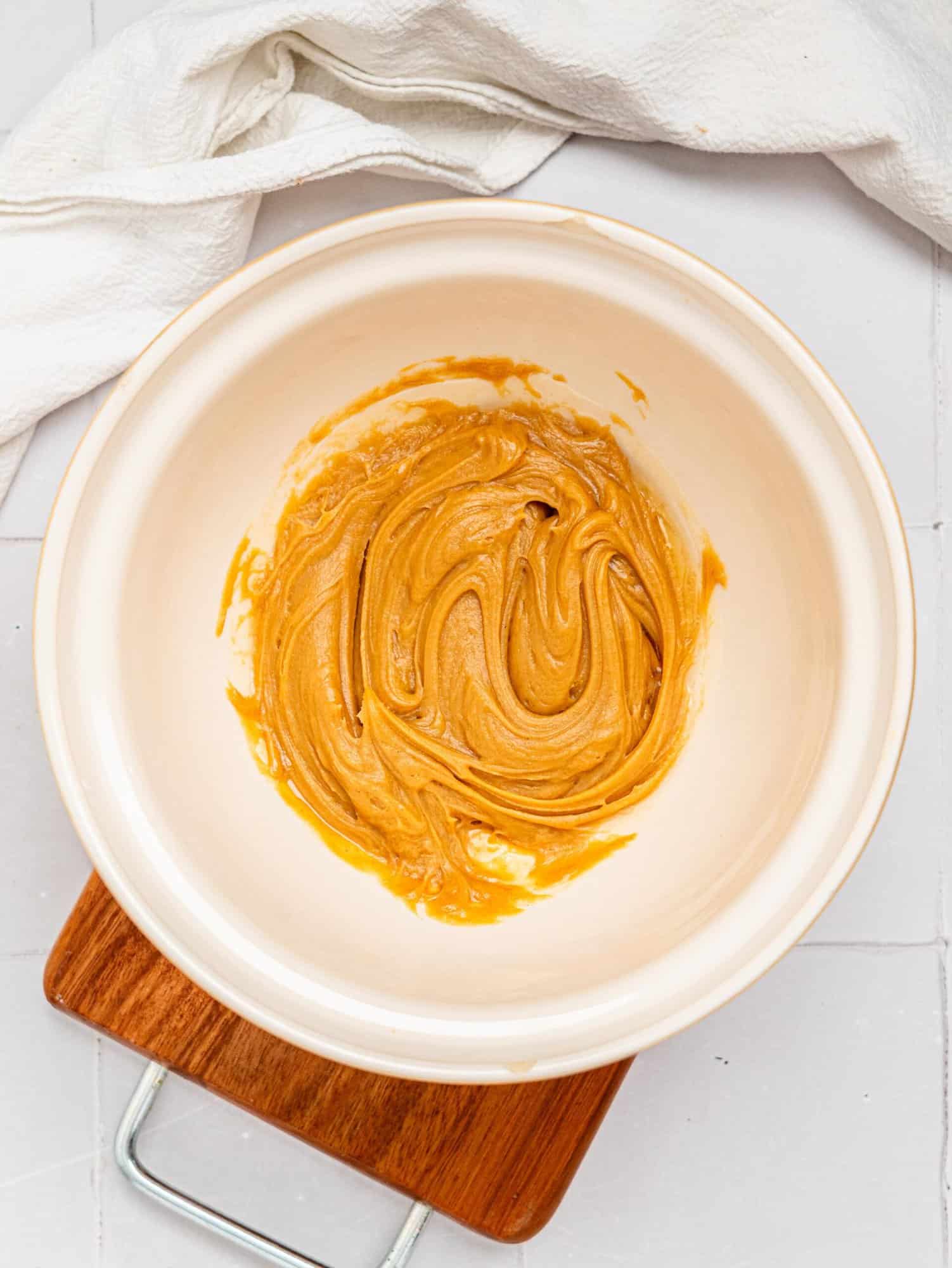 Peanut butter and honey combined in a mixing bowl.