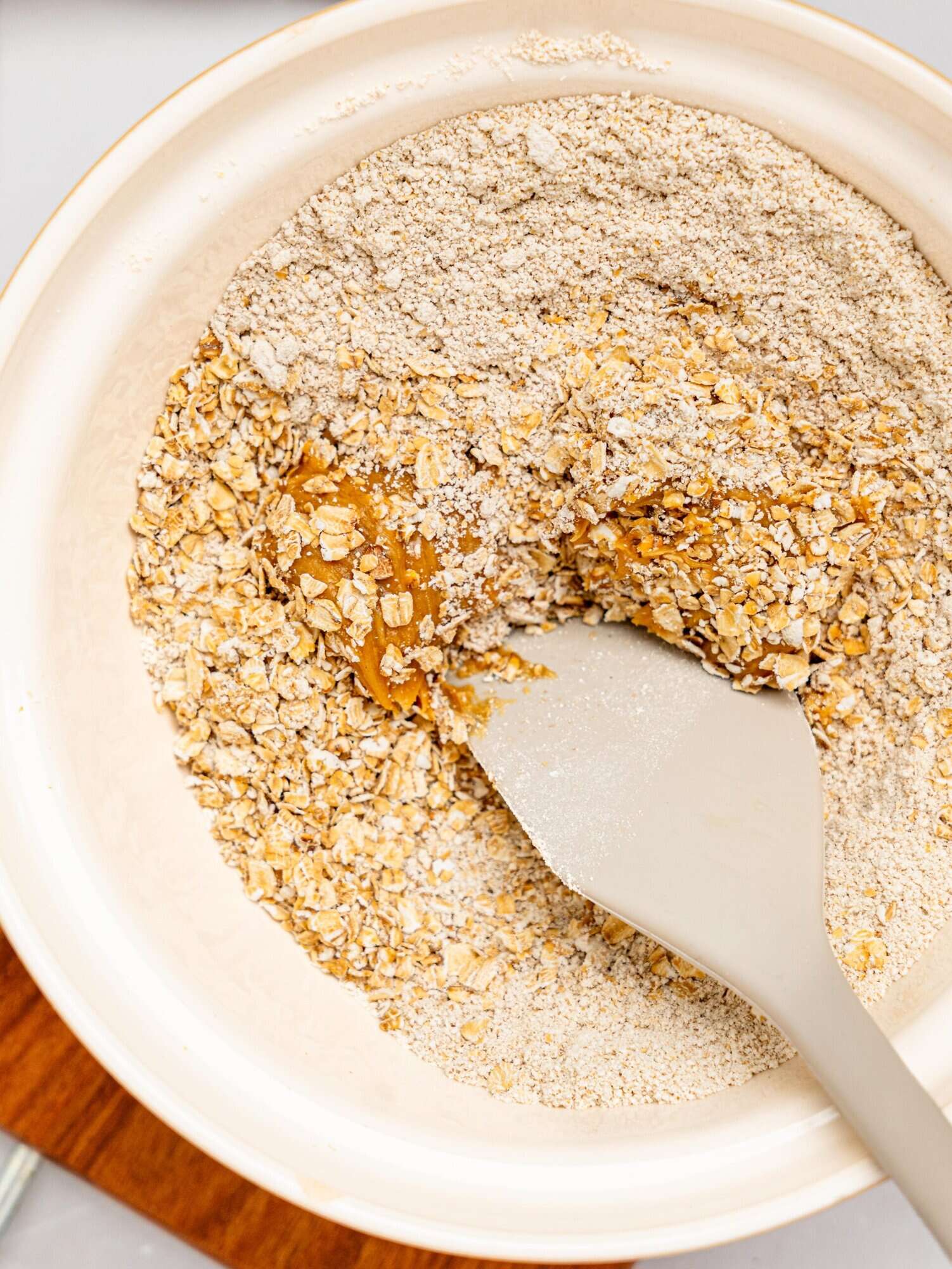 Peanut butter, honey, oats, and oat flour in a mixing bowl.