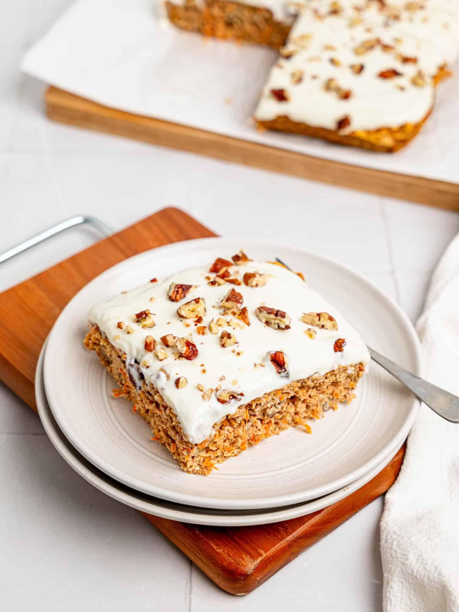 A slice of carrot cake baked oatmeal on a white plate.