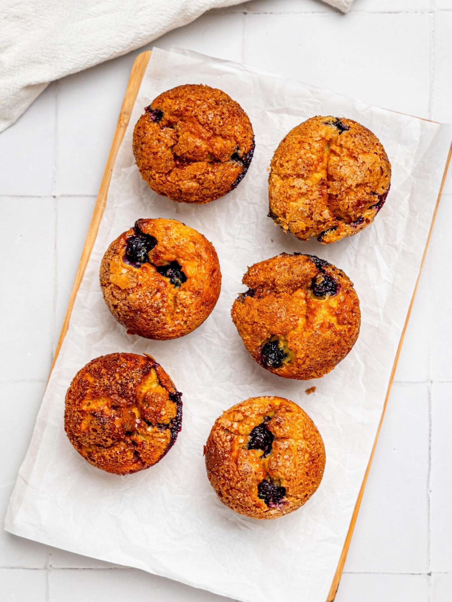 Cottage Cheese Blueberry Muffins on a wooden board.
