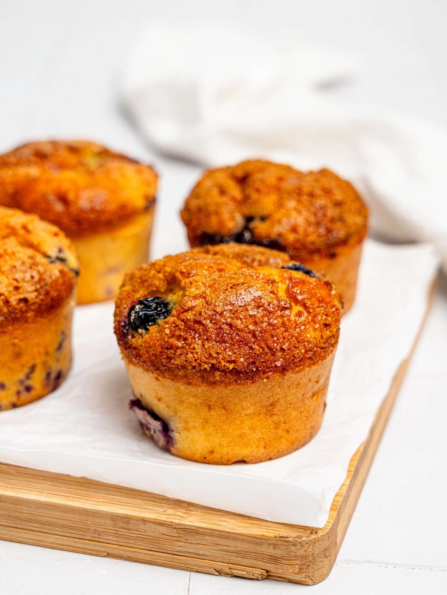 Blueberry Cottage Cheese Muffins on a wooden board.