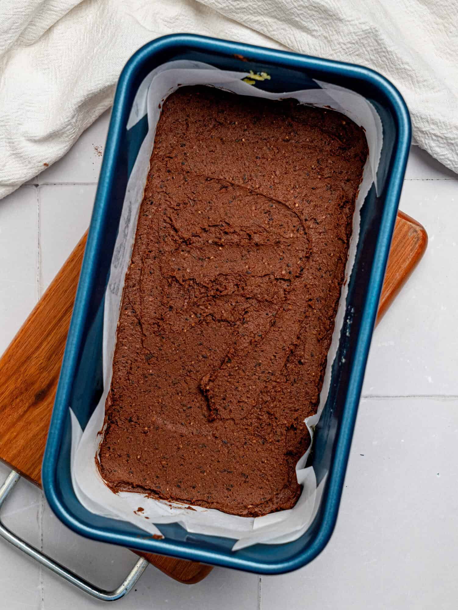 Black bean brownie batter pressed into a loaf pan.