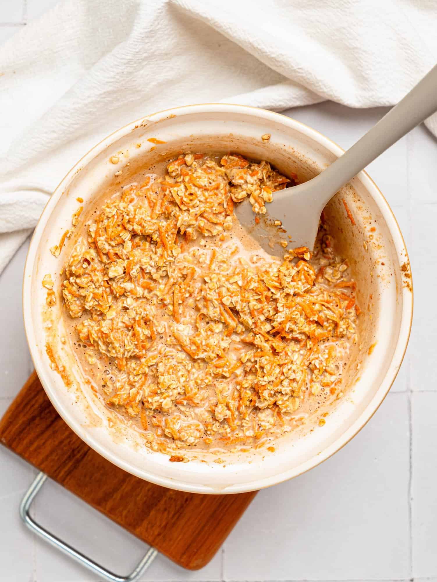 Carrot Cake Baked Oatmeal ingredients combined in a mixing bowl.