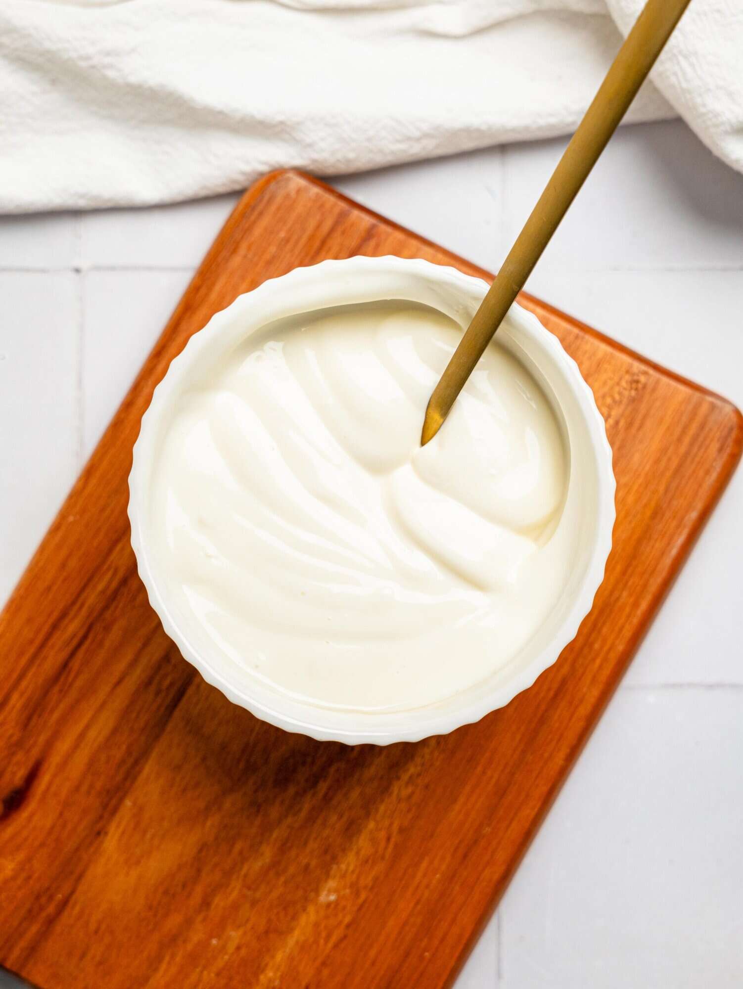 Healthy yoghurt frosting in a small white bowl.
