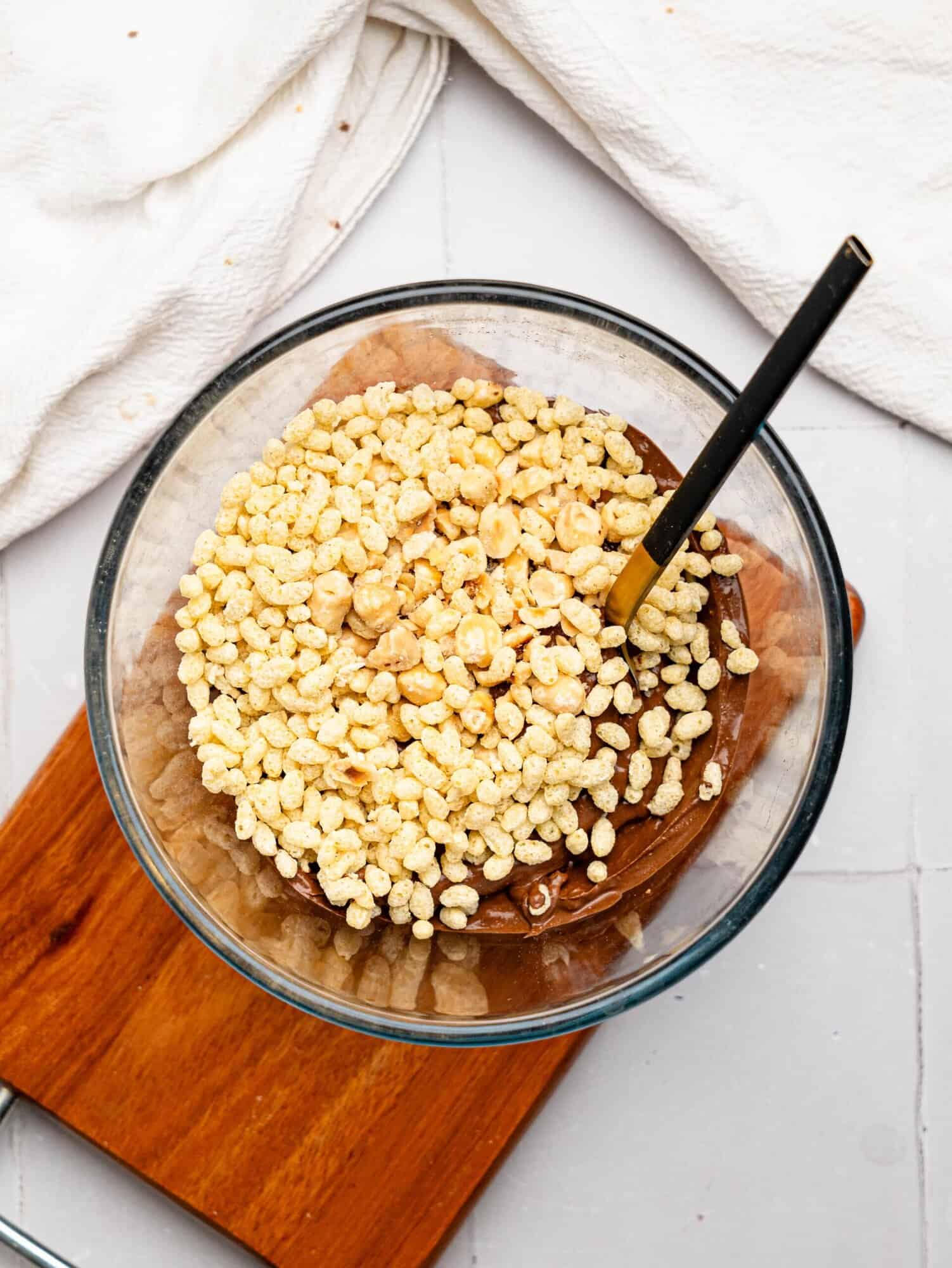 Cottage Cheese Chocolate pudding with puffed rice and hazelnuts in a glass bowl.