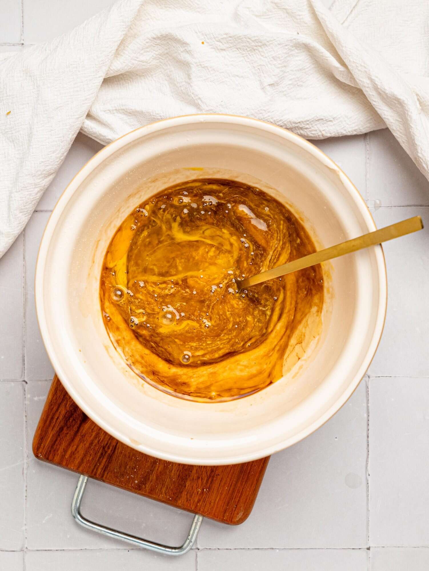 Oat flour blondie batter wet ingredients in a mixing bowl.