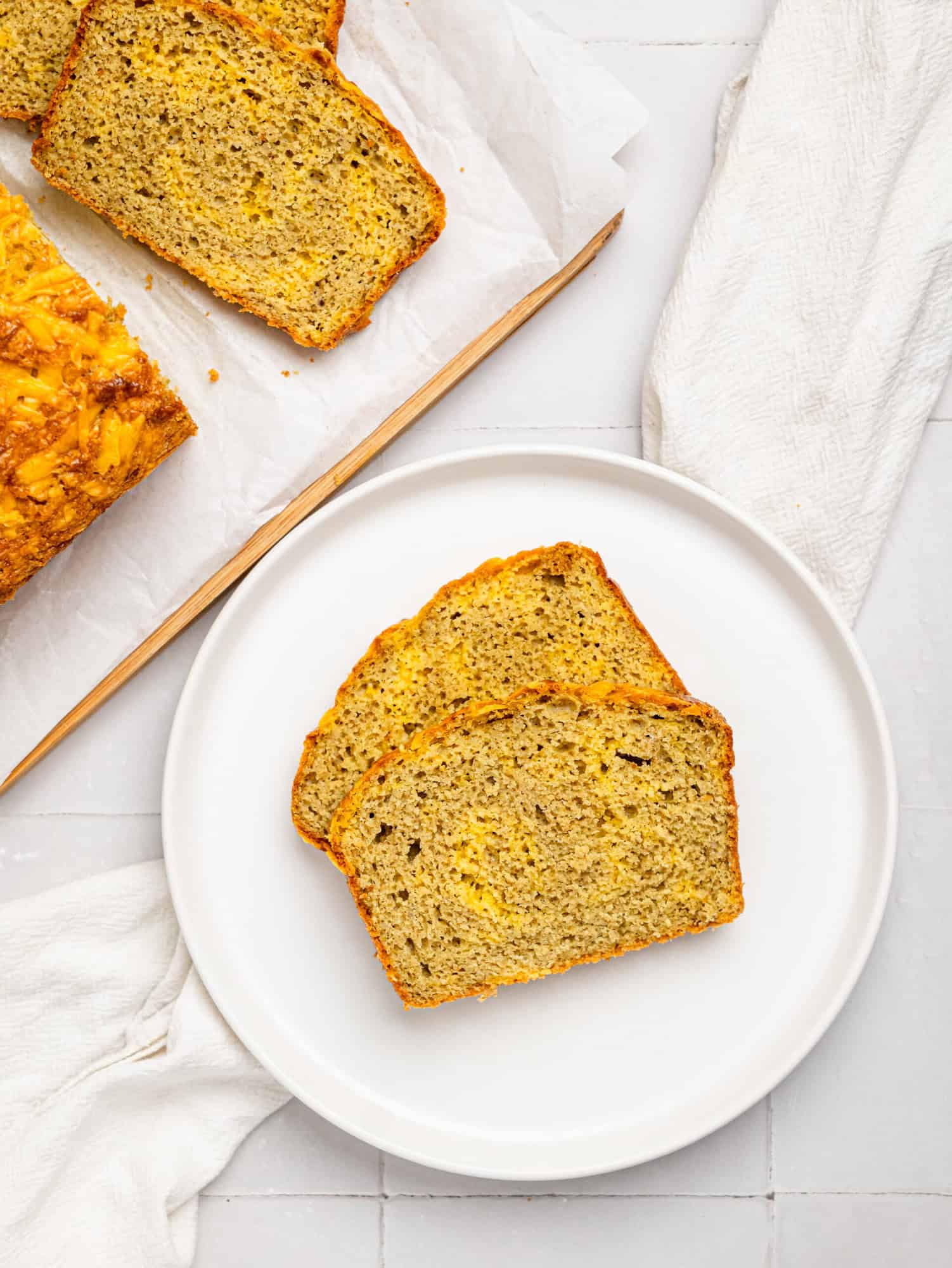 Two slices of oat flour bread on a white plate.