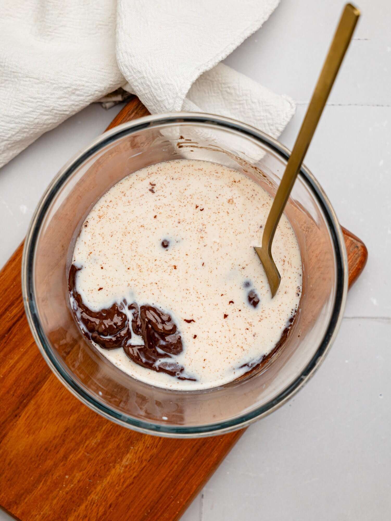 Milk and dark chocolate in a glass mixing bowl - an easy and healthier way to make chocolate ganache.