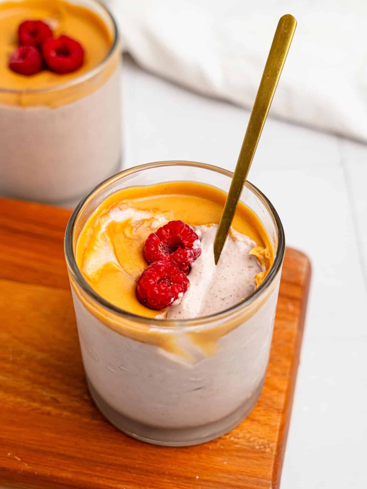 Half-eaten PB & J Blended Overnight Oats in a glass.