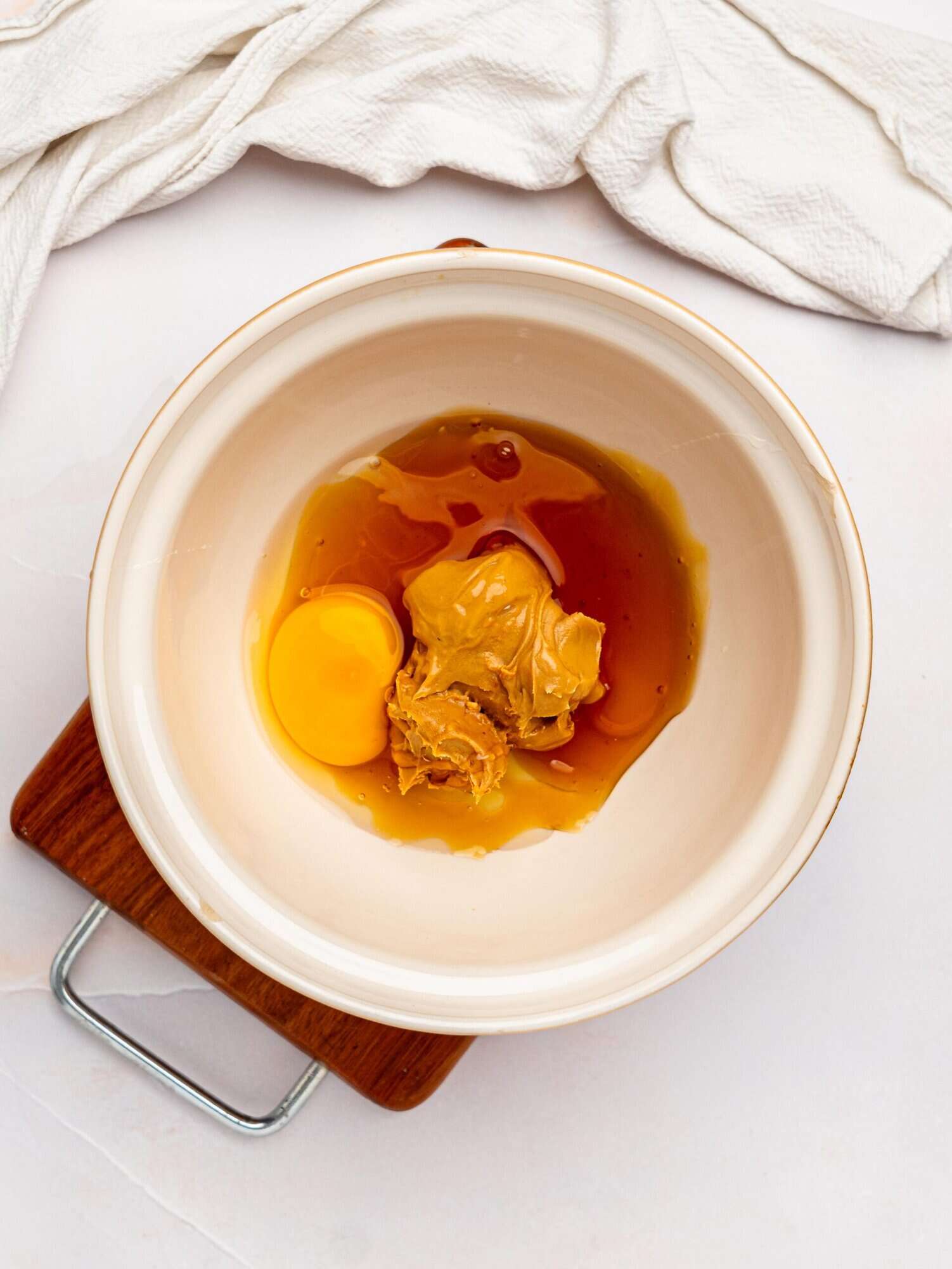 Healthy peanut butter cookie wet ingredients in a mixing bowl.