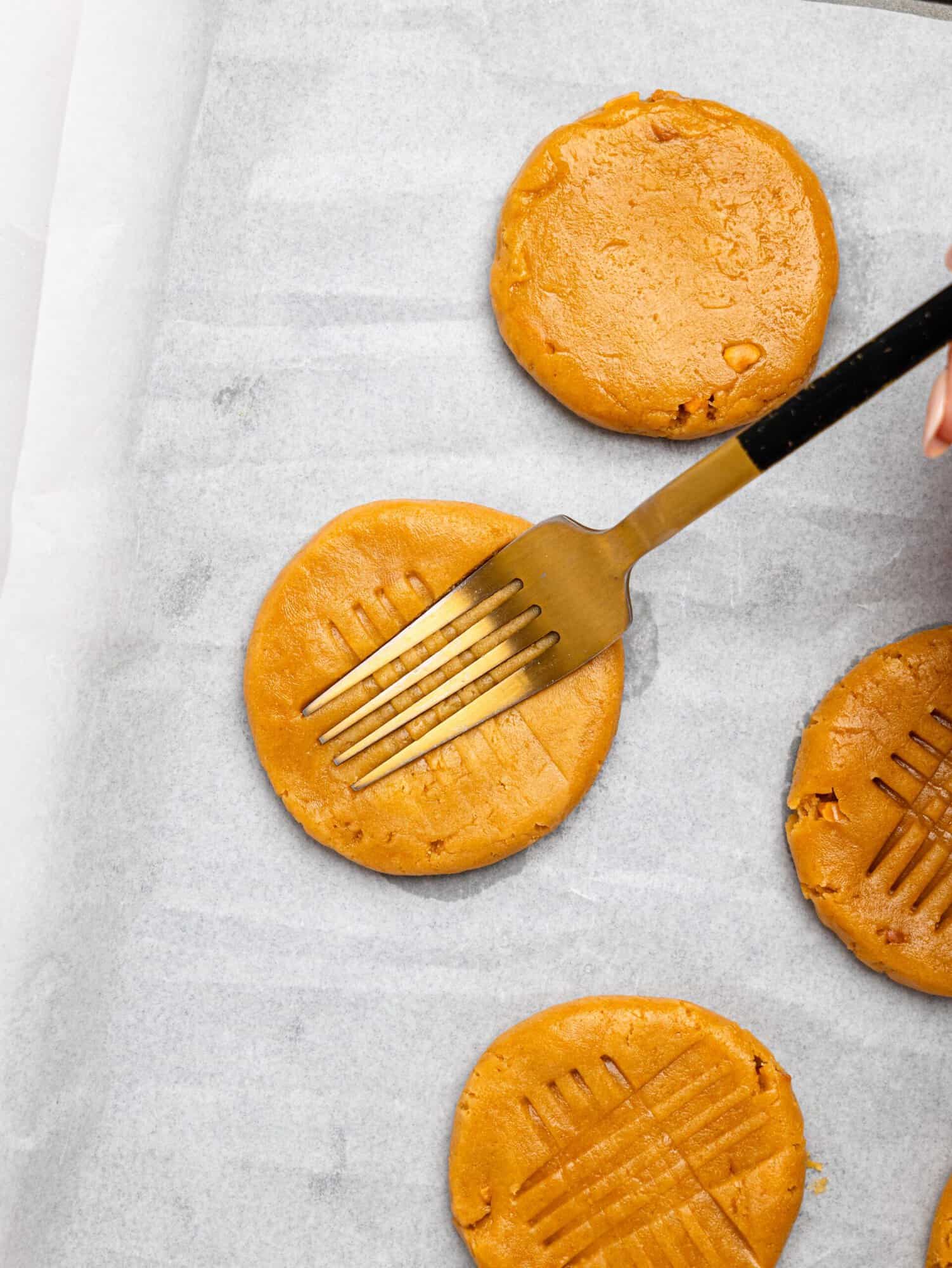 Making the iconic criss cross on peanut butter cookies.