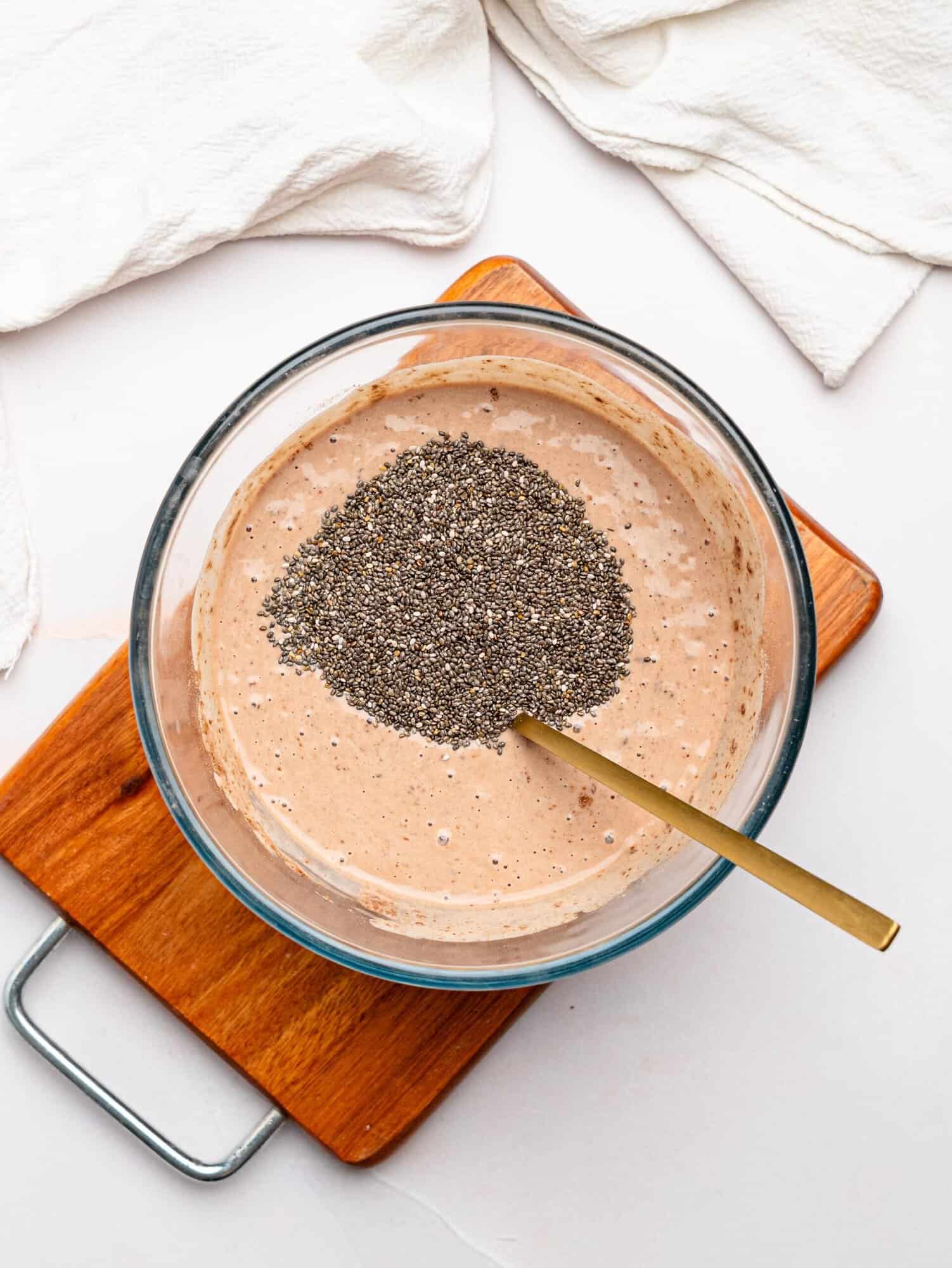 High protein chia pudding ingredients in a glass bowl.