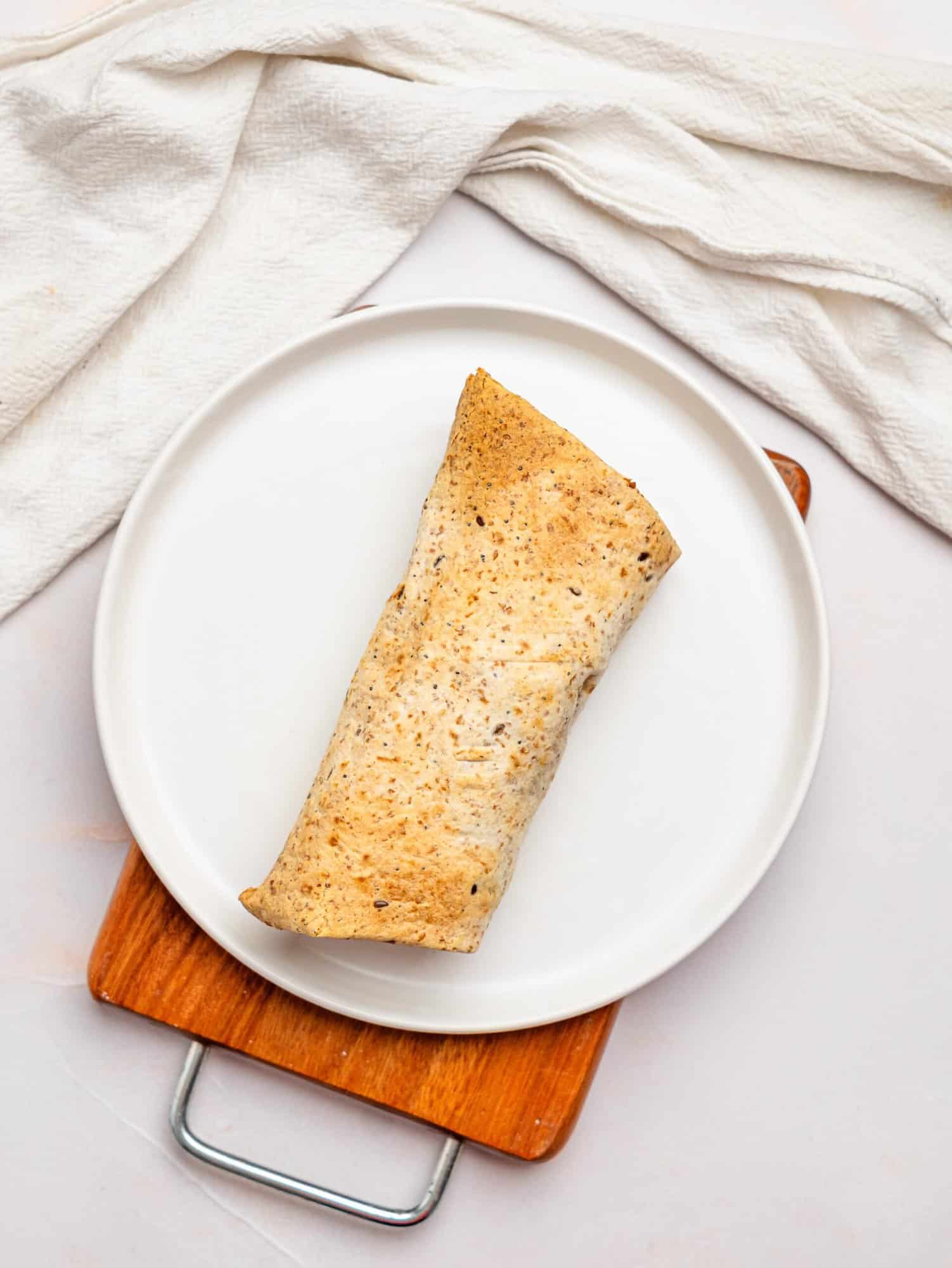 Toasted wrap on a white plate.