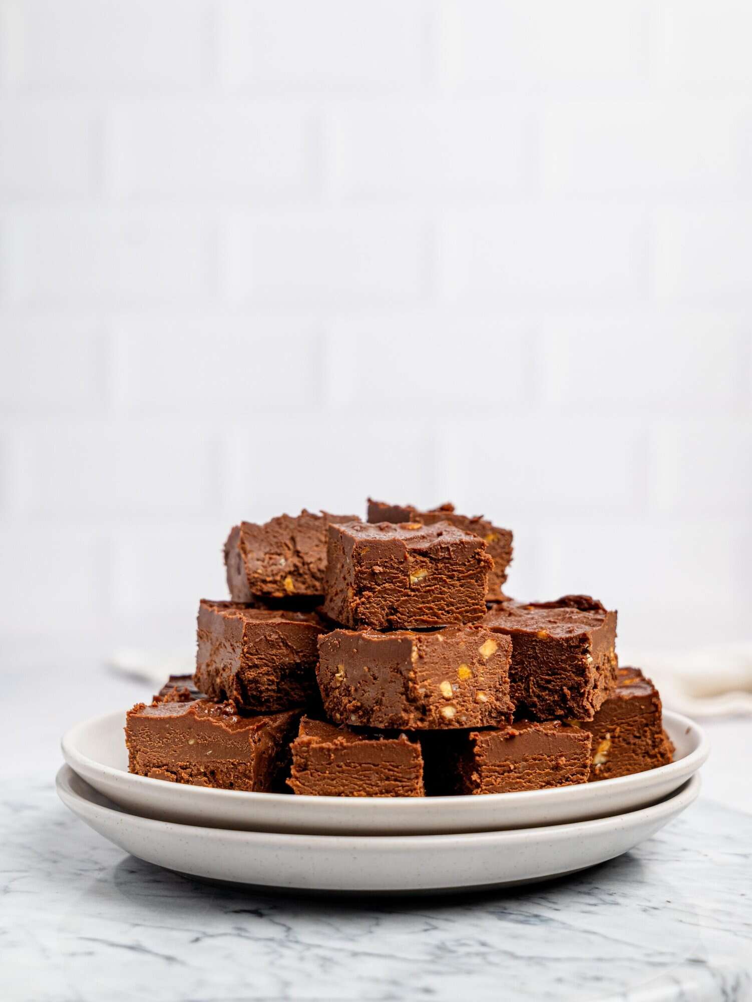 Healthy chocolate fudge stacked on a plate.