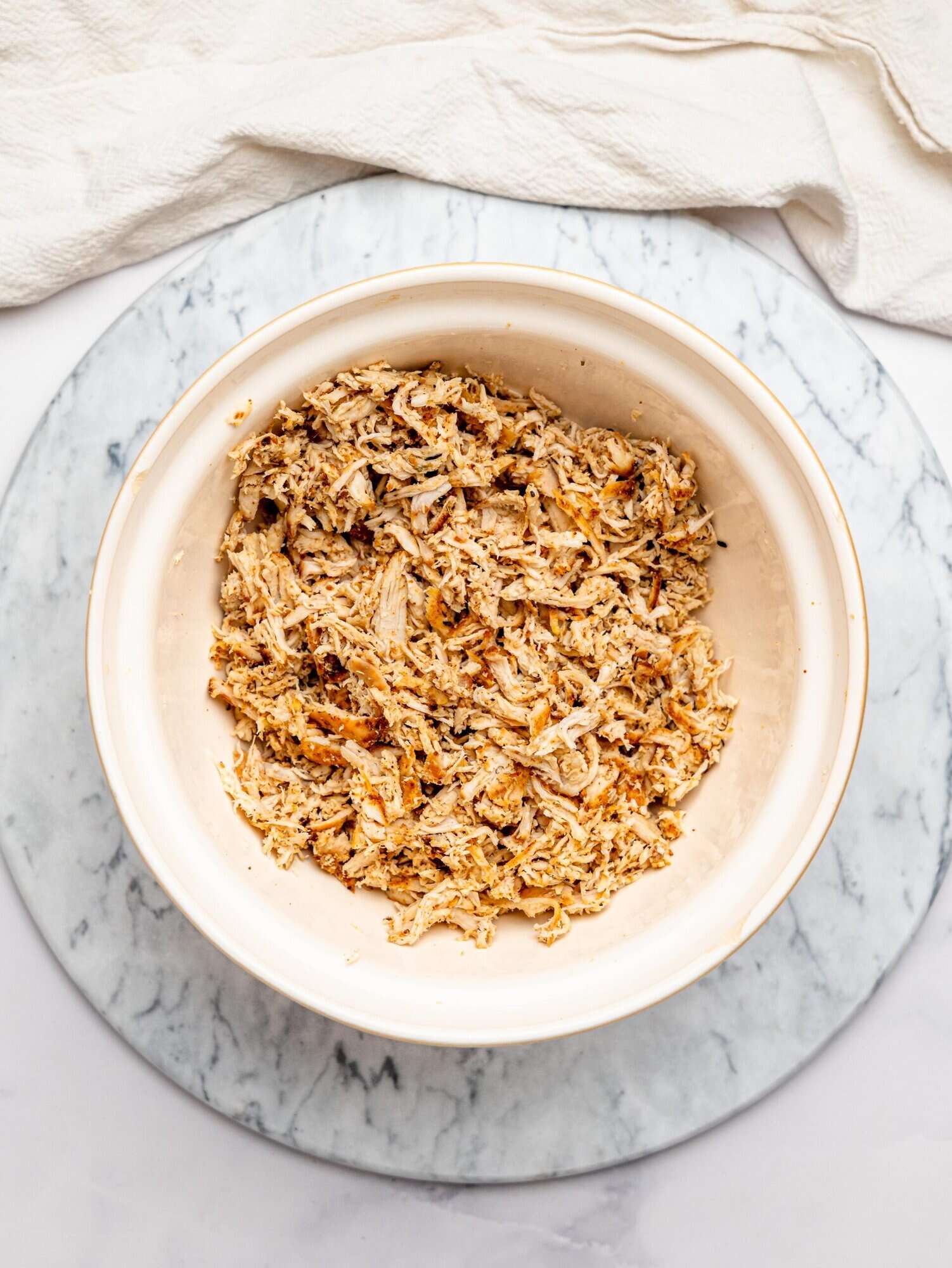 Shredded chicken in a mixing bowl.